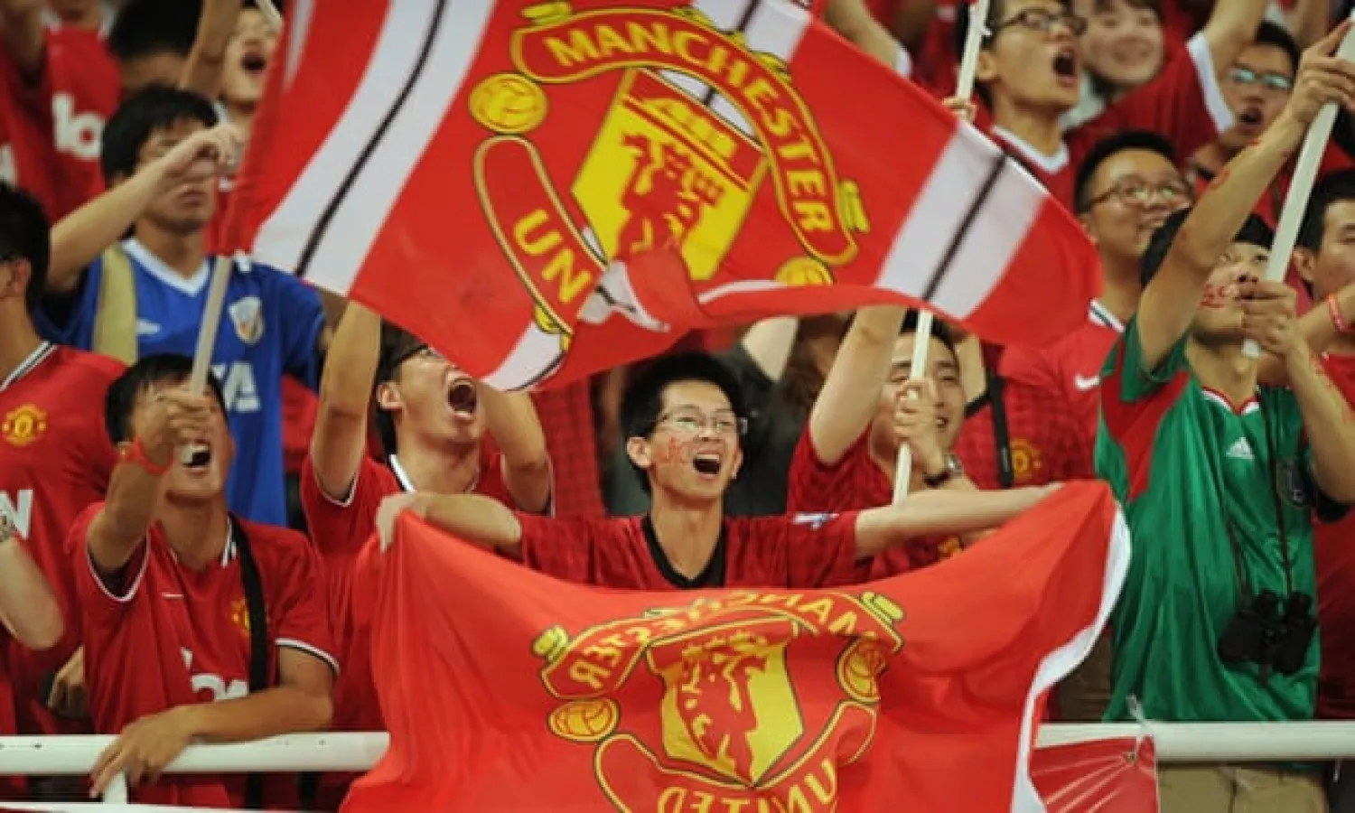  Manchester United fans wait for the start of a friendly against Shanghai Shenhua in the Chinese city in 2012. Photograph: Peter Parks/AFP/Getty Images
