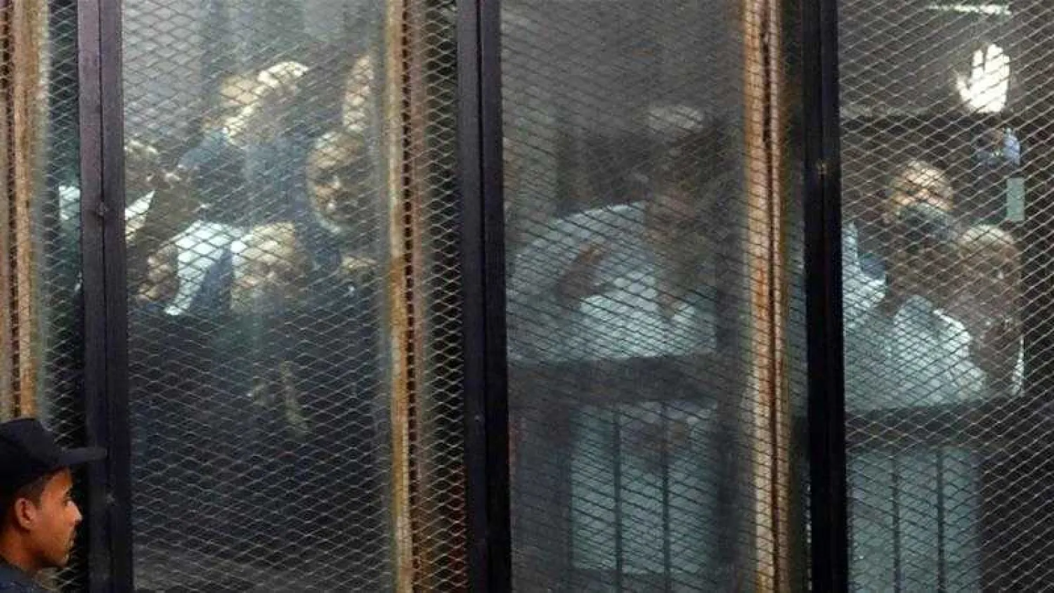 File photo: Muslim Brotherhood members are seen behind bars during a court session in Cairo. Amr Abdallah Dalsh/Reuters
