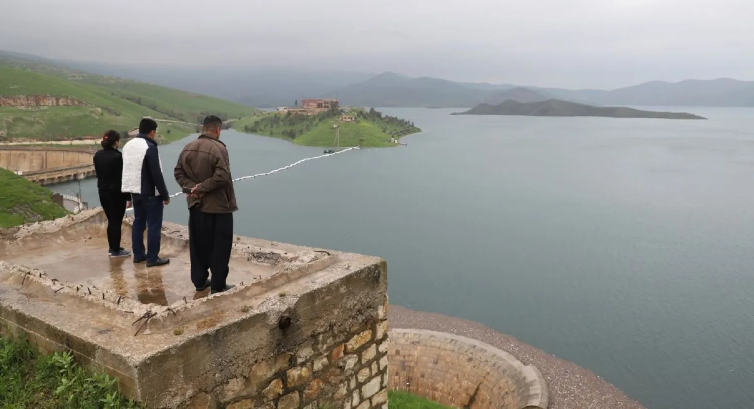 People look out over the Dukan dam in Iraq's northern autonomous region of Kurdistan, where waters have reached their highest level since the facility was built in 1955. (AFP)