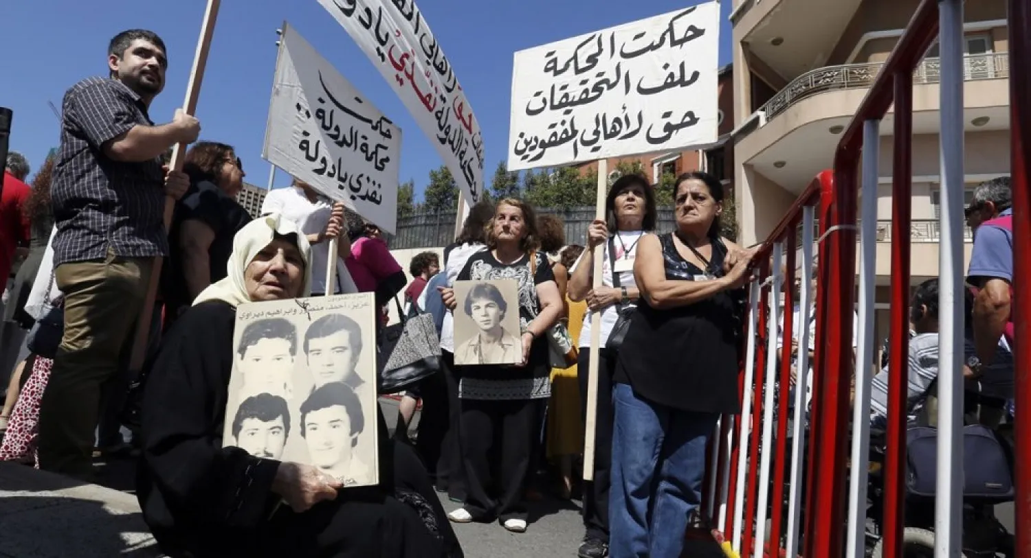 Women hold pictures of relatives who went missing during Lebanon's civil war during a protest in front of the government palace in Beirut, September 18, 2014. (Reuters)