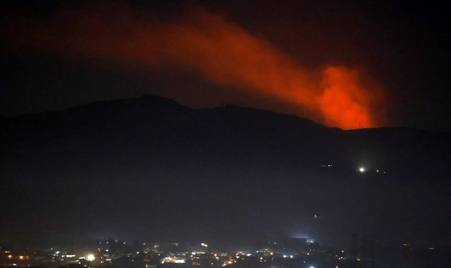 Smoke rises past a mountain after an Israeli strike as seen from the Damascus countryside, Syria December 25, 2018. (Reuters)