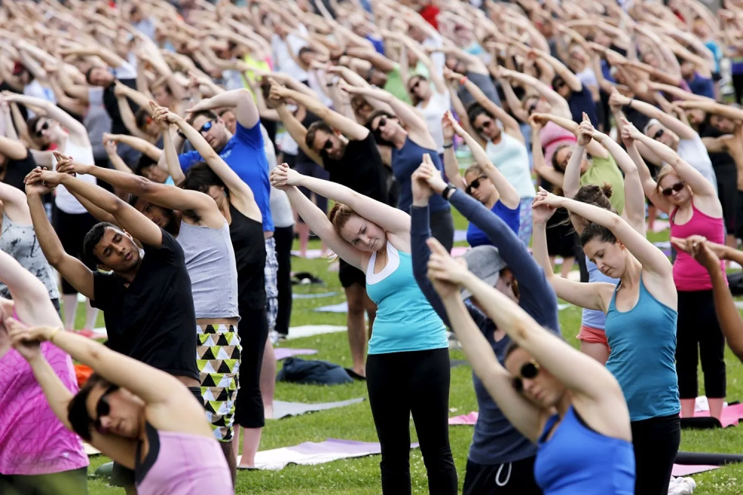 People take part in a free weekly yoga class on the lawn of Parliament Hill in Ottawa, Canada, on July 22, 2015. (Reuters)