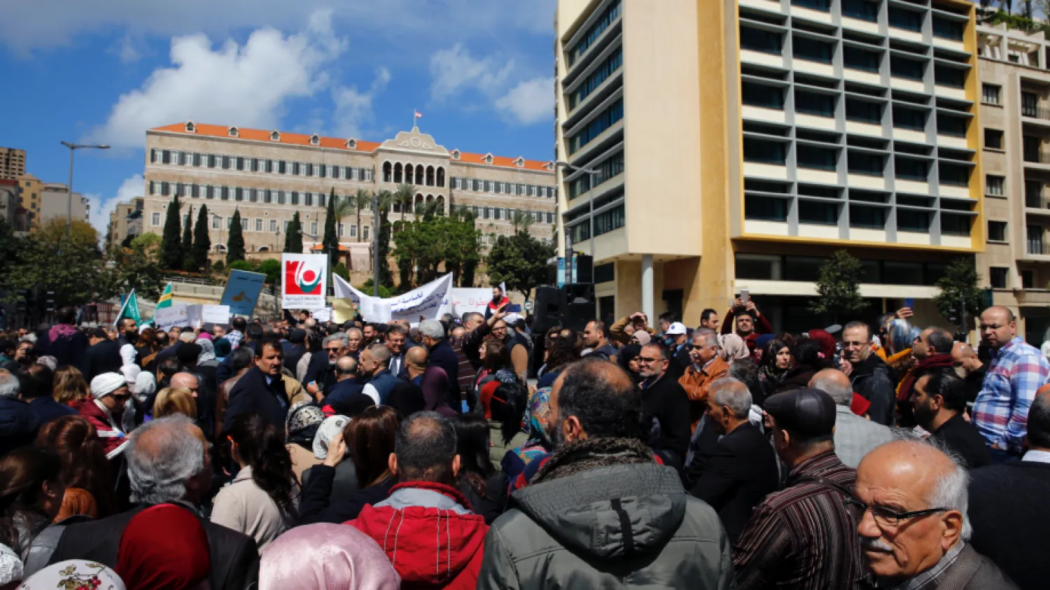 Civil servants protest in front of the government building during a parliament session to approve a plan to restructure the country's electricity sector, in Beirut, Lebanon, Wednesday, April 17, 2019. (AP Photo/Bilal Hussein)