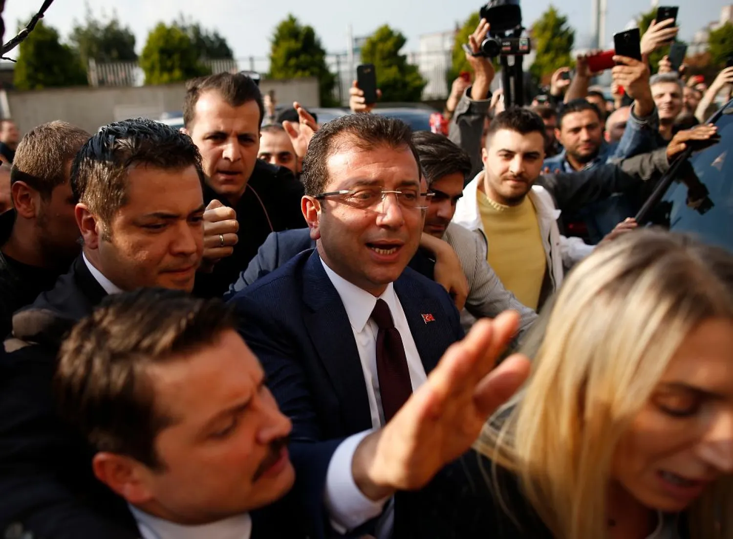 Ekrem Imamoglu, centre, of the opposition Republican People's Party (CHP) mayoral candidate in Istanbul, arrives to receive a certificate confirming his win by a slim margin against ruling party's candidate Binali Yildirim, in Istanbul, Turkey, Wednesday, April 17, 2019. (AP Photo/Emrah Gurel)