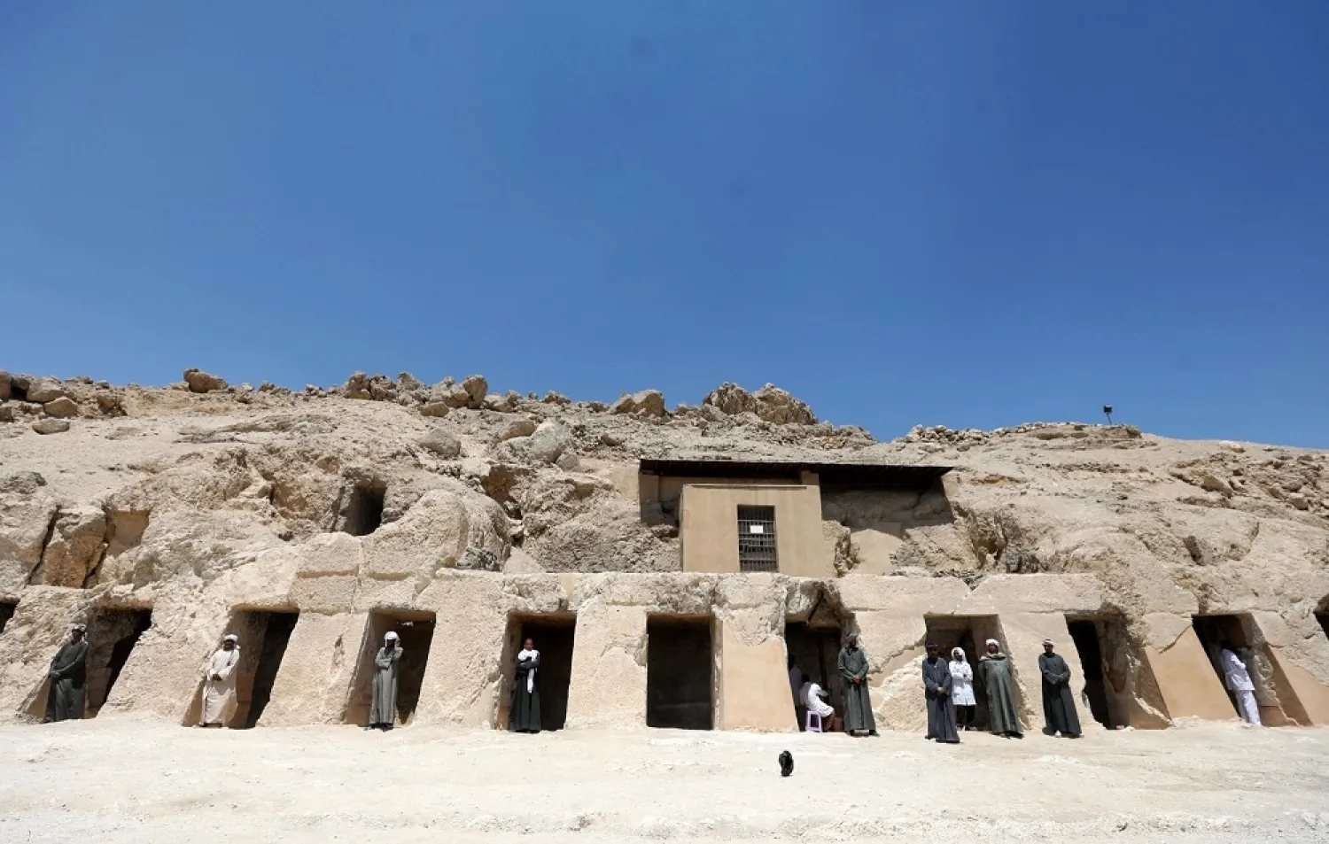 Workers standing inside the gates of one of the largest newly discovered tombs Shedsu Djehuty in Luxor, Egypt April 18, 2019. (Reuters)