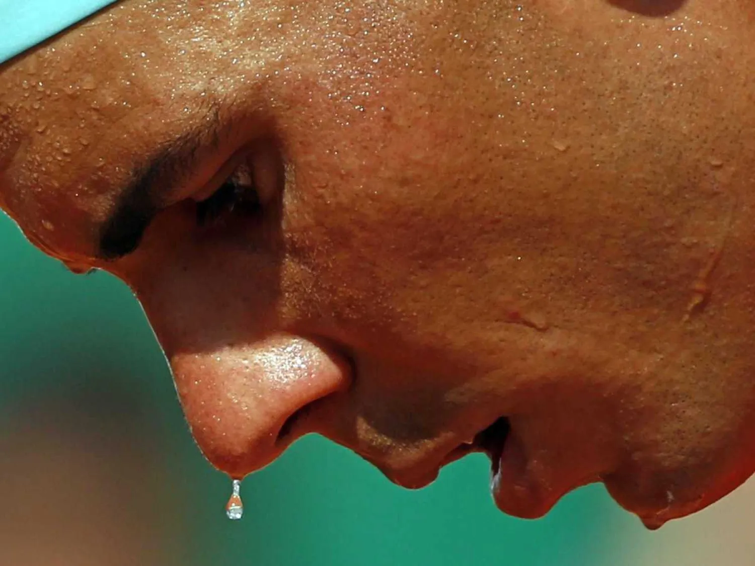 Drop of sweat falls from tennis player Rafael Nadal. REUTERS/Eric Gaillard.