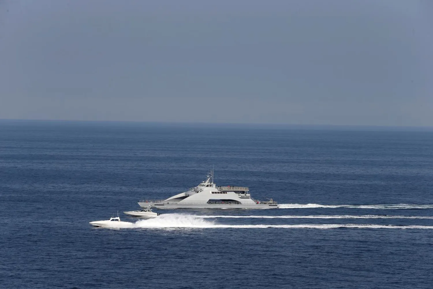 FILE PHOTO: Iranian Revolutionary Guards speed boats are seen near the USS John C. Stennis CVN-74 (not pictured) as it makes its way to Gulf through Strait of Hormuz, December 21, 2018. REUTERS/Hamad I Mohammed