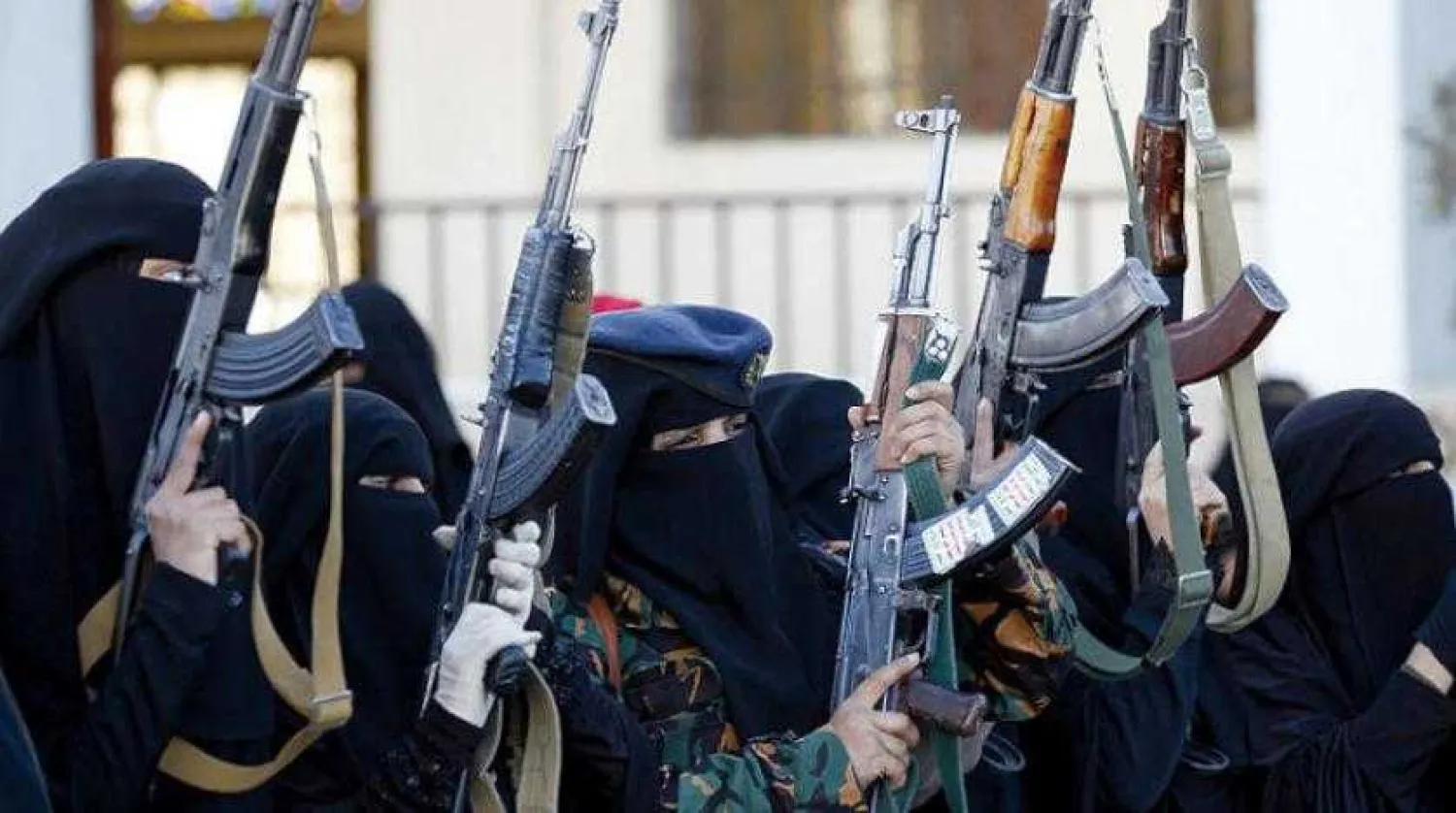 Members of all-female Houthi militias raise arms at insurgency support rally. Getty Images