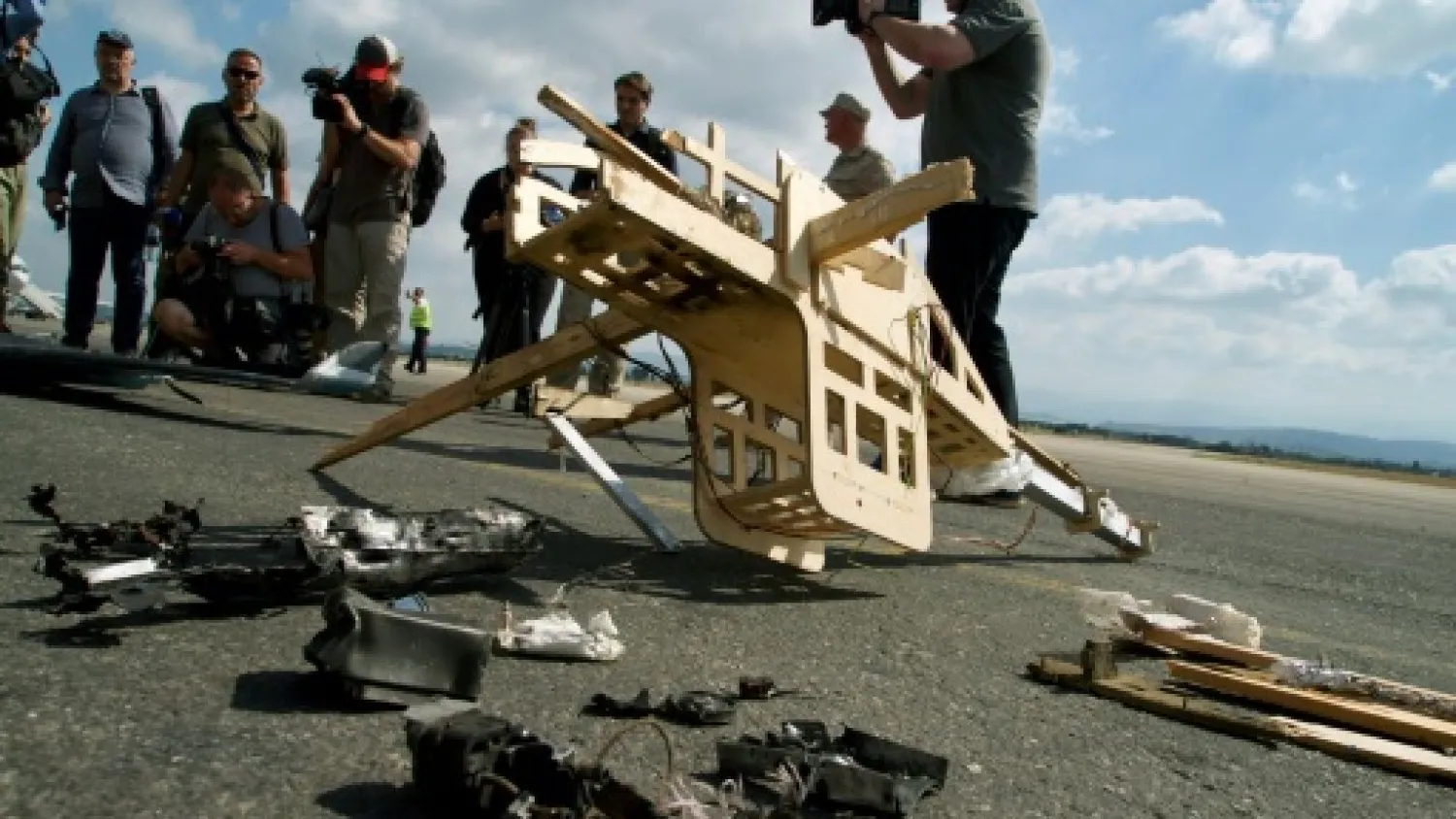  Russian soldiers display the remains of what they said was a drone belonging to rebel fighters shot down over the Russian air base in Hmeimim in the northwestern Syrian province of Latakia on August 16 AFP
