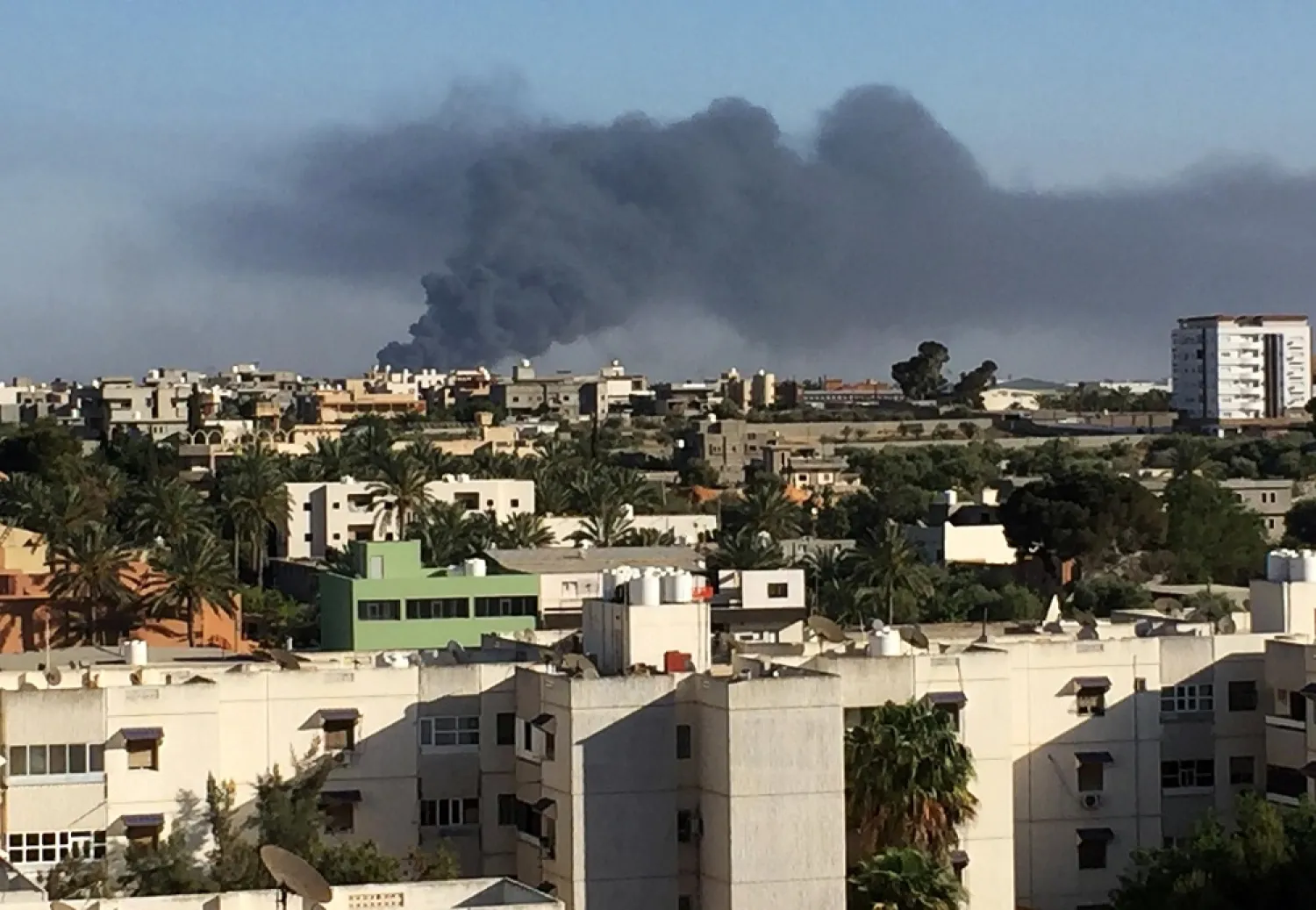 Smoke rises from clashes between the LNA and pro-GNA forces in Ain Zara, Tripoli on May 5, 2019. (Reuters)