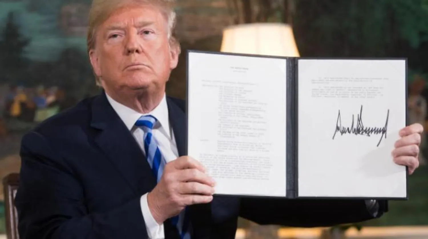الرئيس الأميركي دونالد ترمب لدى توقيعه إعادة فرض العقوبات على إيران بعد الانسحاب من الاتفاق النووي (صورة أرشيفية - أ.ف.ب)