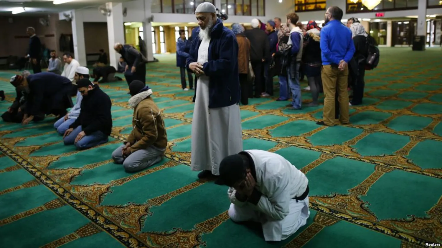 Men pray as visitors are given a tour of the Birmingham Central Mosque, on visit my mosque day in Birmingham, Feb. 7, 2016.
