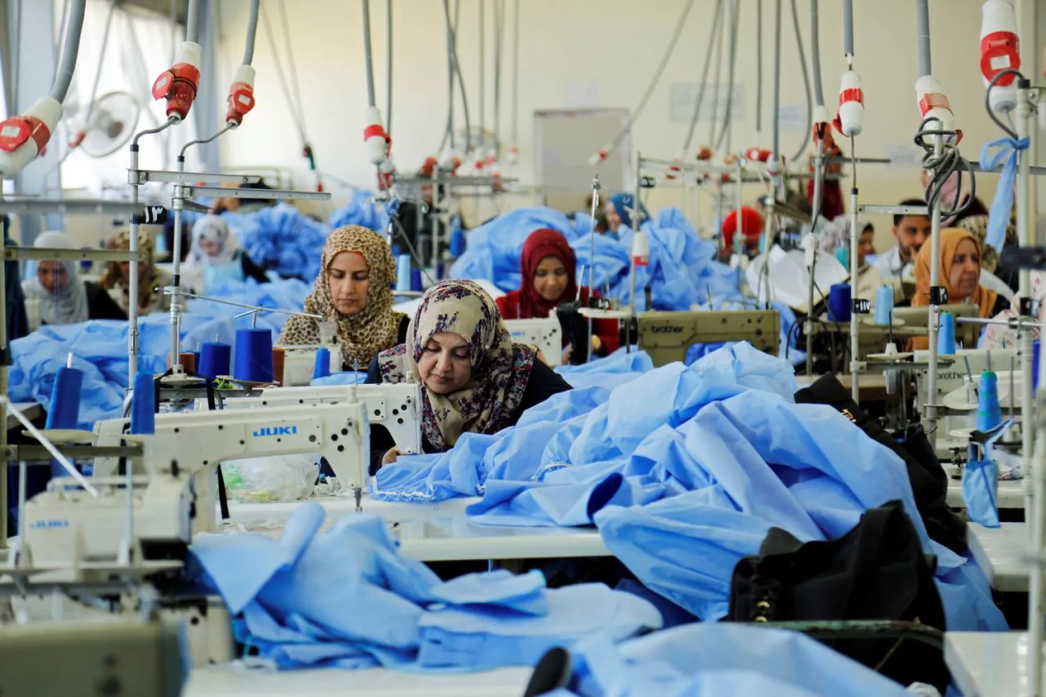 Women sew clothes at Waladi textile factory, part of which was destroyed by the war in Mosul, Iraq May 5, 2019. (Reuters)