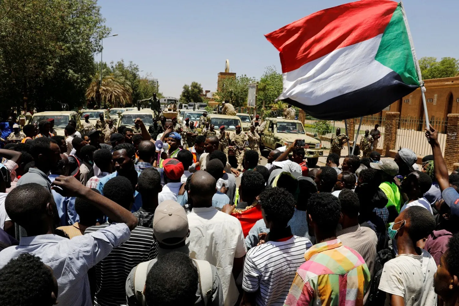 Sudanese demonstrators chant slogans in front of security forces during a protest in Khartoum. (Reuters)