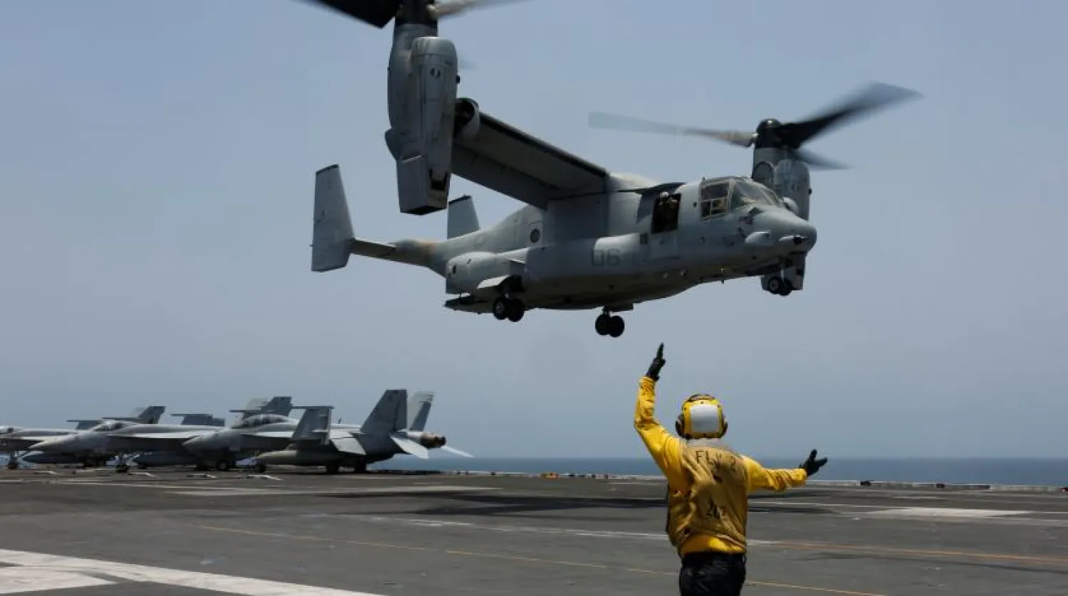 In this Friday, May 17, 2019, photo released by the US Navy, Aviation Boatswain's Mate 2nd Class Nicholas Hawkins, from Houston, Texas, signals an MV-22 Osprey to land on the flight deck of the Nimitz-class aircraft carrier USS Abraham Lincoln in the Arabian Sea. (Mass Communication Specialist 3rd Class Amber Smalley/US Navy via AP)