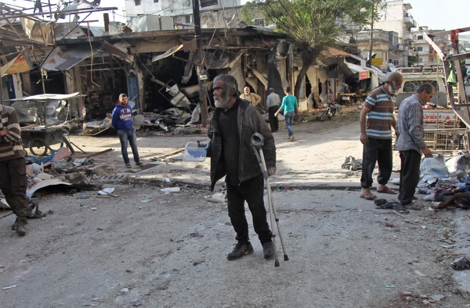 A Syrian man whose shop was destroyed in a regime aerial bombardment the previous day walks around the area on May 15, 2019 in Jisr al-Shughur in Idlib province. (AFP)