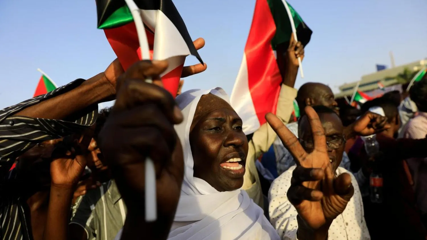 Sudanese protesters wave national flags at a demonstration in front of the Defense Ministry compound in Khartoum, Sudan, on May 1, 2019. (Reuters)