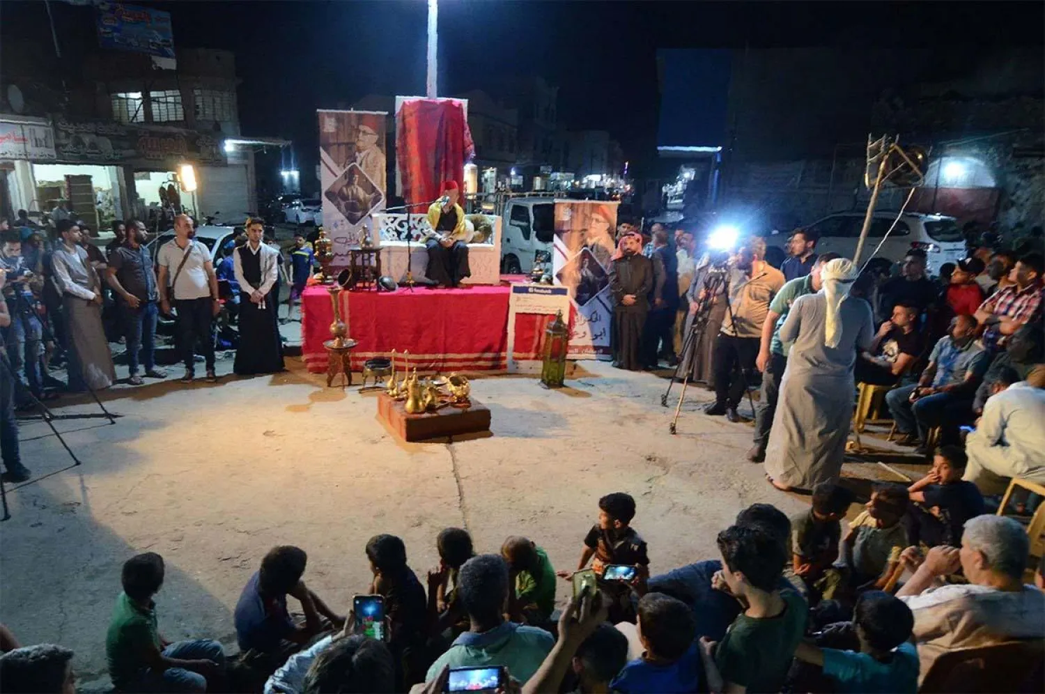 Traditional storyteller Abdel Wahed Ismail (on stage), entertains an audience in the northern Iraqi city of Mosul | AFP