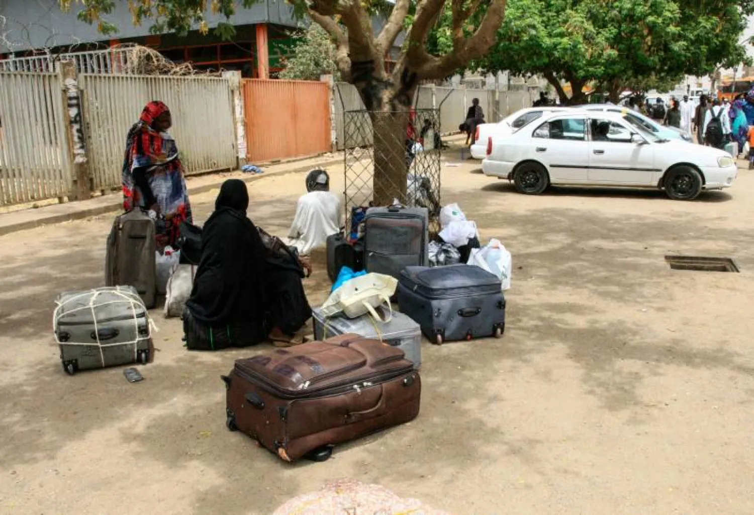 Stranded passengers wait at Khartoum's main bus terminal where drivers and other staff overwhelmingly observed a strike called by protest leaders to raise the pressure on Sudan's ruling generals to step down | AFP