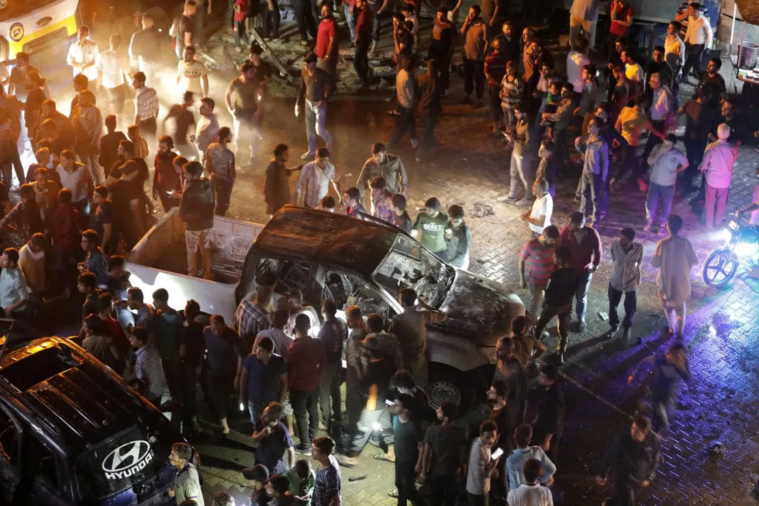 People gather at the site of a car bomb blast in Azaz, Syria June 2, 2019. (Reuters)