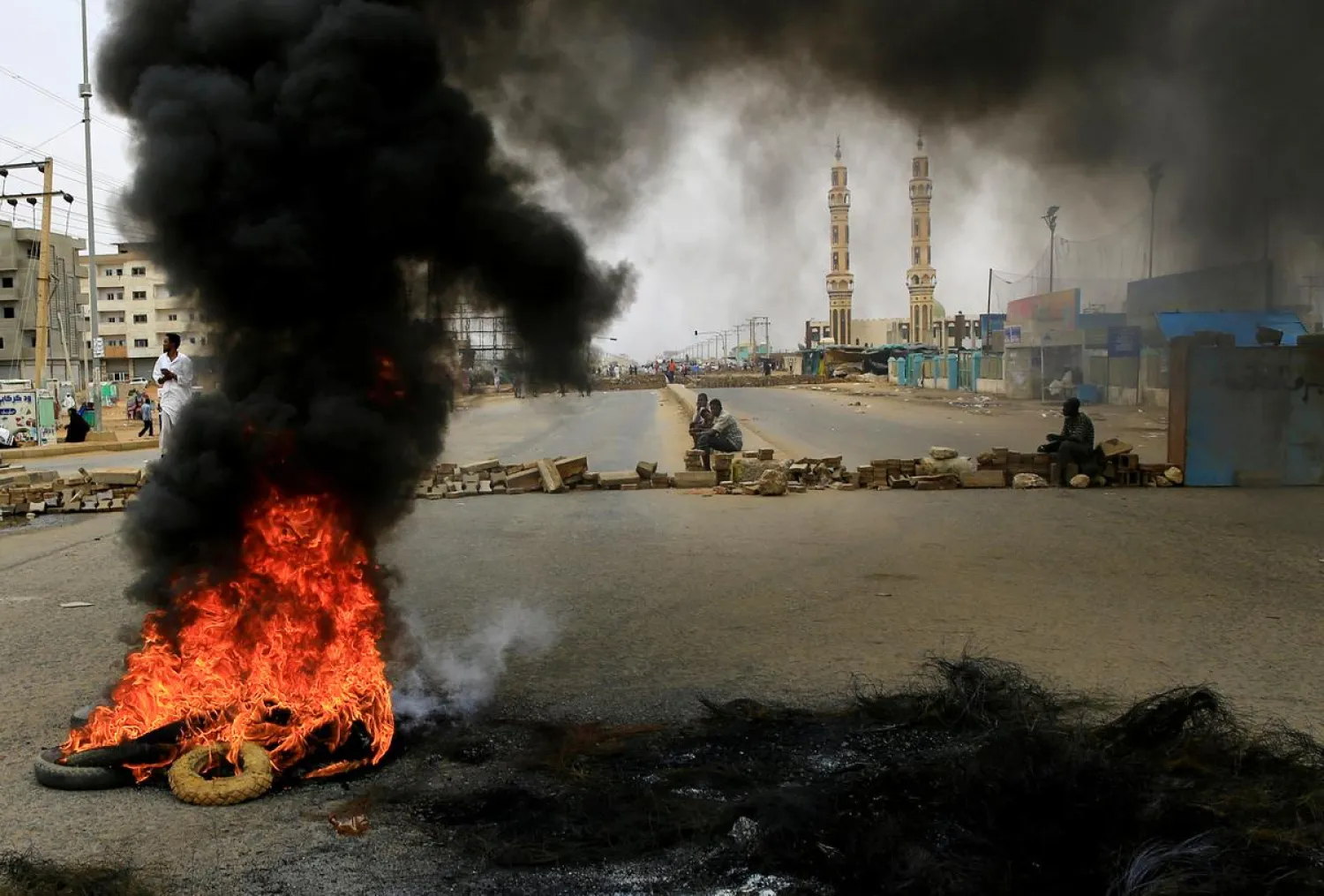 Sudanese protesters are seen near burning tyres used to erect a barricade on a street, demanding that the country's Transitional Military Council handover power to civilians, in Khartoum, Sudan June 4, 2019. REUTERS/Stringer