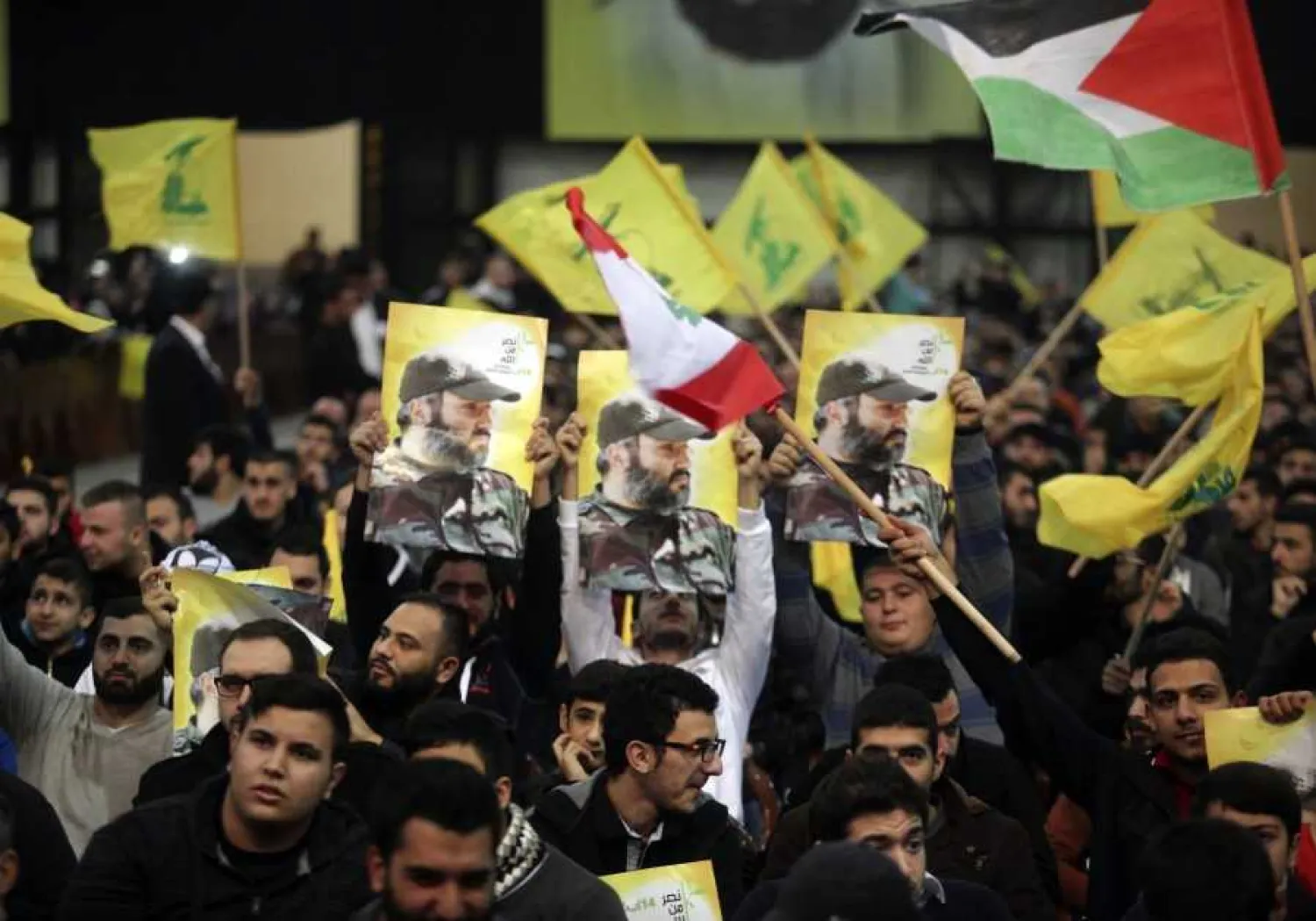 File photo: Hezbollah supporters carry pictures of the party's late military leader Imad Moughniyeh (photo credit: REUTERS/KHALIL HASSAN)