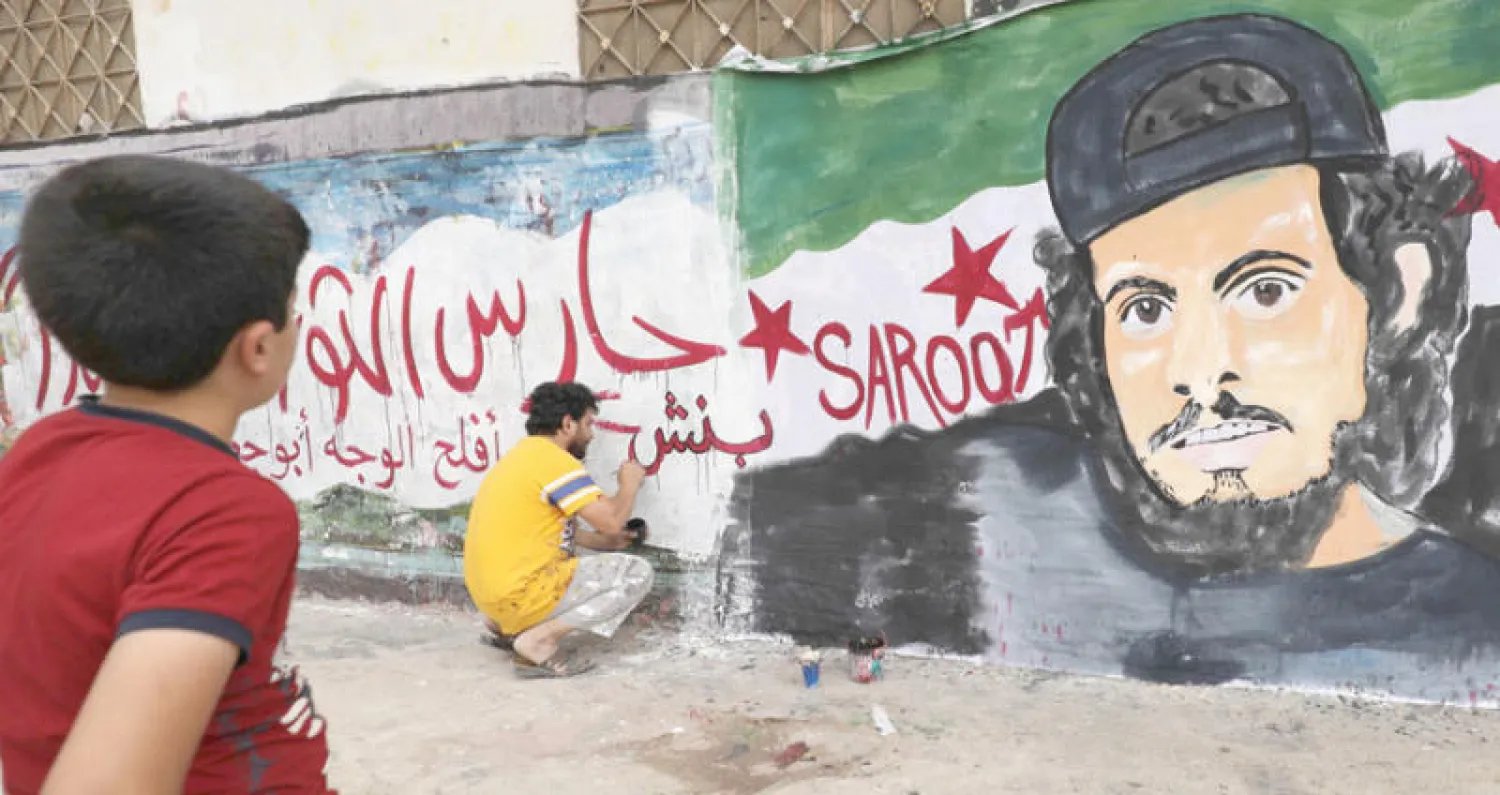 لوحة رسمها نشطاء معارضون في ريف ادلب امس (أ. ف.ب)