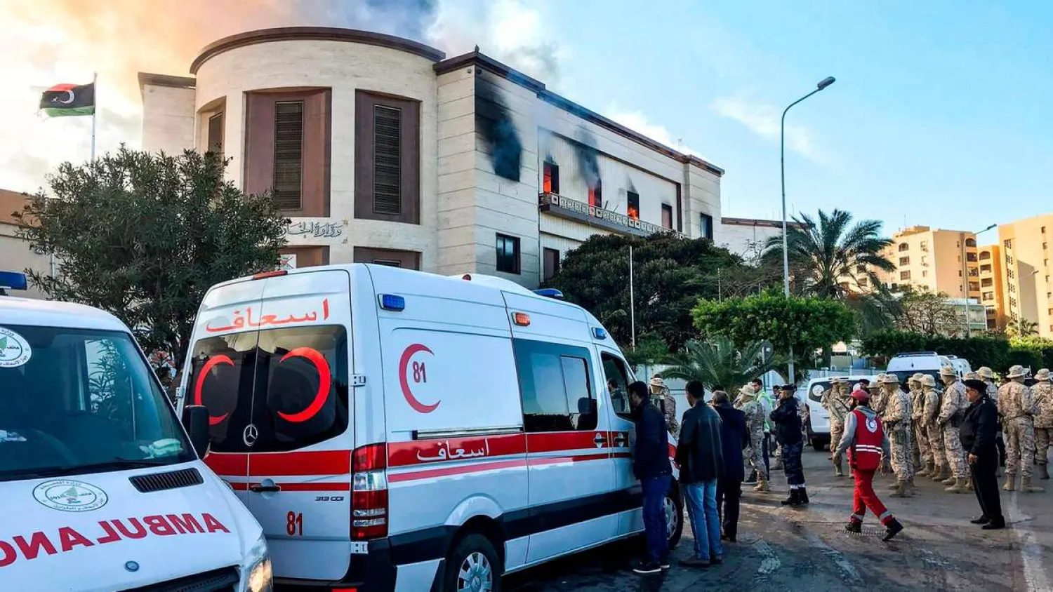 Ambulances, paramedics, and security officers at the scene of an attack outside the Libyan foreign ministry headquarters in the capital Tripoli. AFP