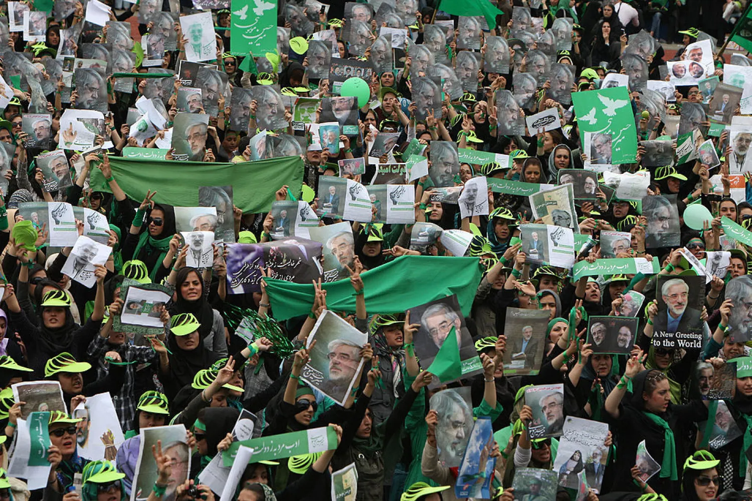Supporters of then Iranian presidential candidate Mir Hossein Mousavi wave green flags - his campaign color - at a pro-reform rally in Tehran on June 9, 2009