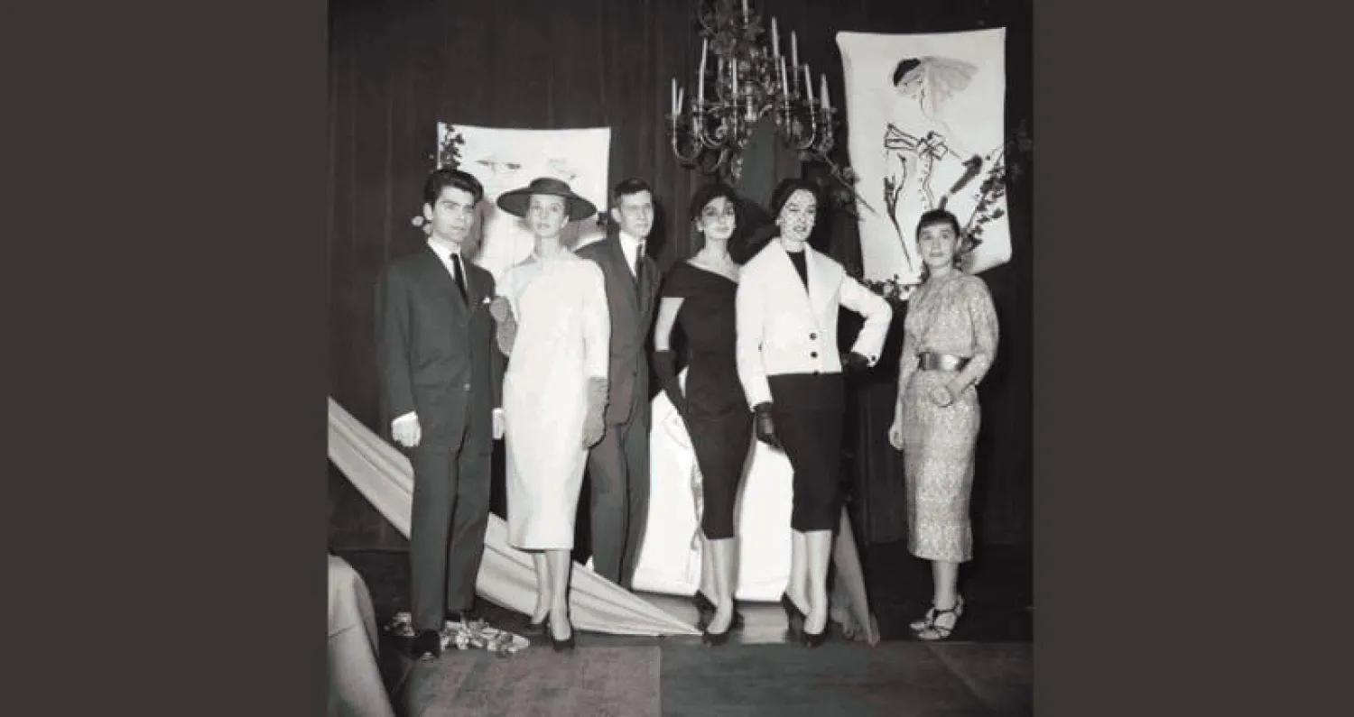 كارل لاغرفيلد (يسار) وإيف سان لوران عندما فاز الأخير بأول جائزة عالمية لتصميم الأزياء في باريس (غيتي)