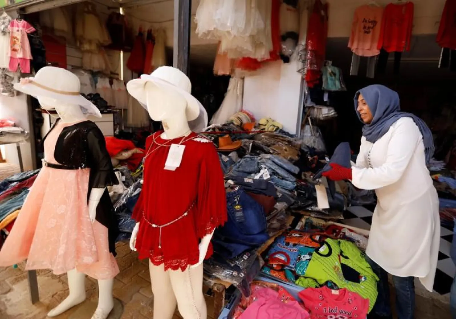 A vendor displays clothing for sale at "Souk Libya" marketplace in the town of Ben Guerdane, near the Libyan border in Tunisia May 24, 2019. REUTERS/Zoubeir 