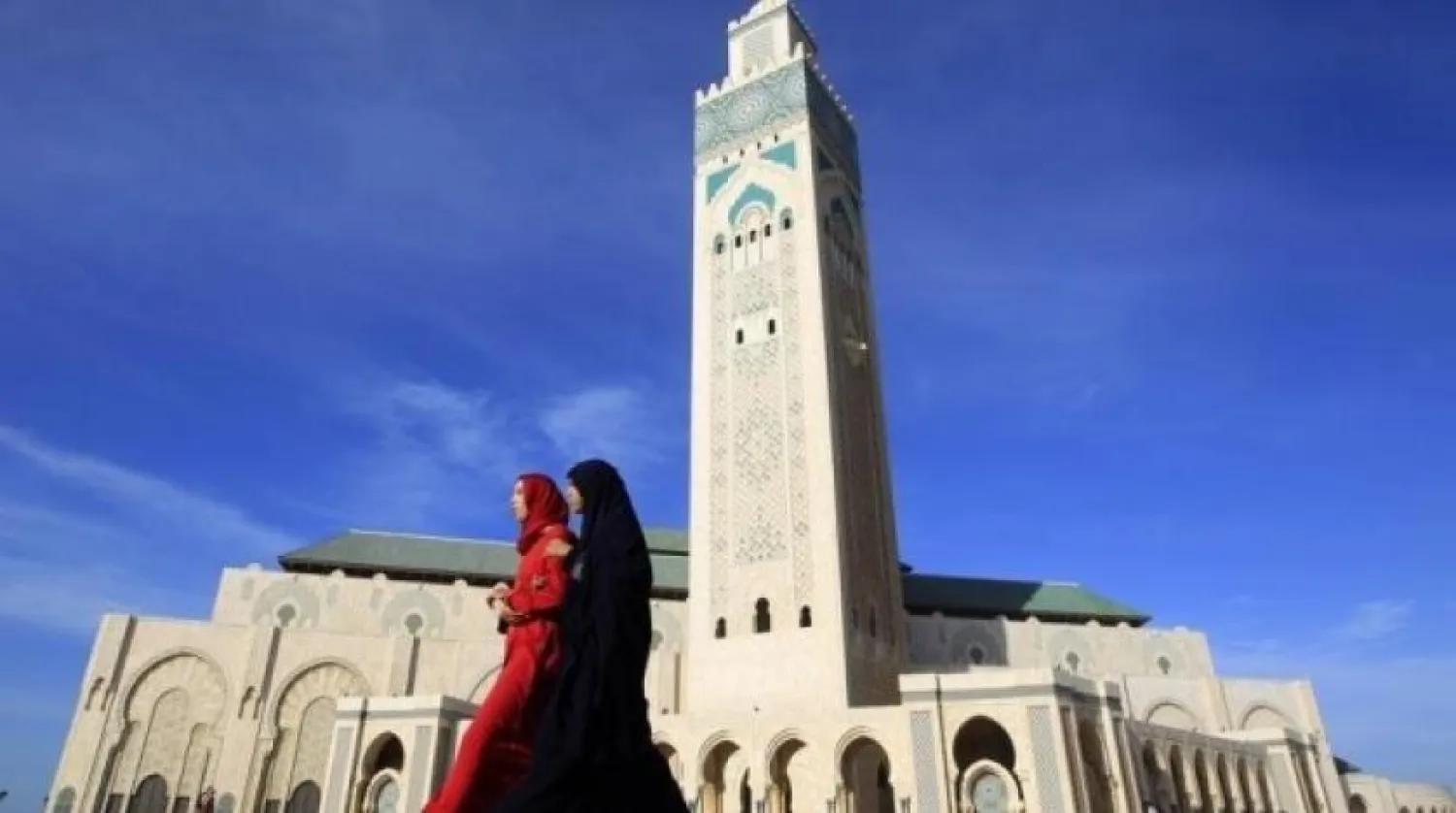 Moroccan women walk past the Hassan II mosque in Casablanca February 24, 2011. REUTERS/Pascal Rossignol