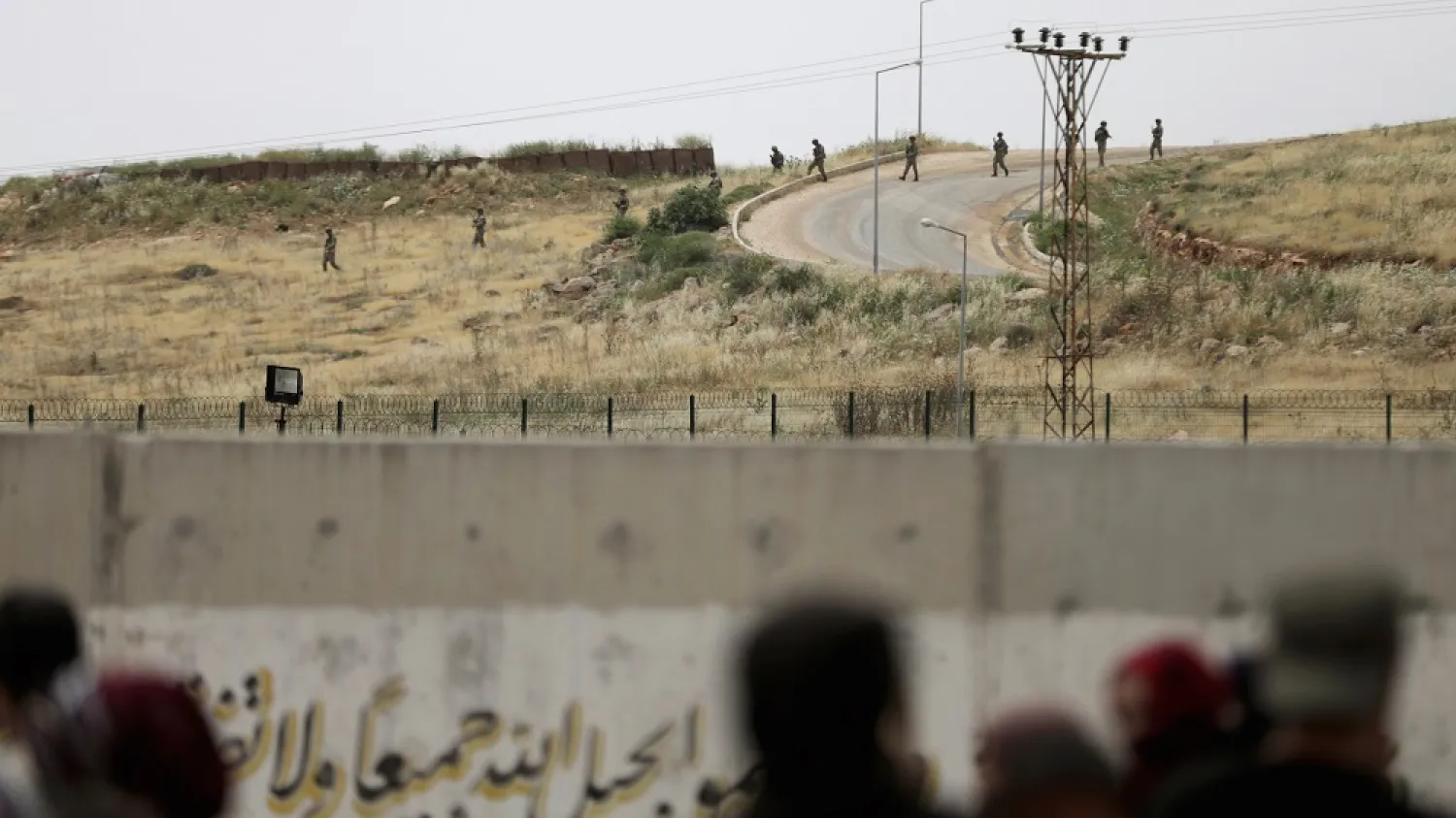 Turkish soldiers walk at the Atmeh crossing on the Syrian-Turkish border, as seen from the Syrian side, in Idlib governorate, Syria, May 31, 2019. (Reuters)