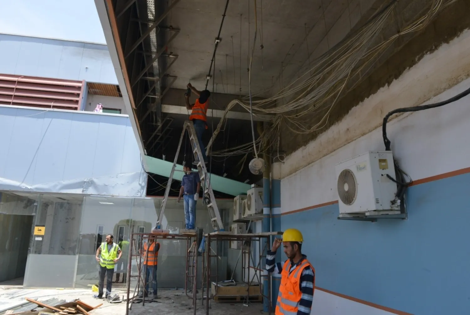 Workers fix the damage at Abha airport after a Houthi missile attack. — AFP