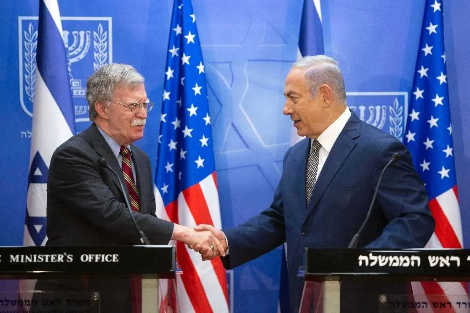 File photo: Israeli Prime Minister Benjamin Netanyahu (R) shakes hands with John Bolton, US national security adviser, in Jerusalem on August 20, 2018 (AFP Photo/Sebastian Scheiner)