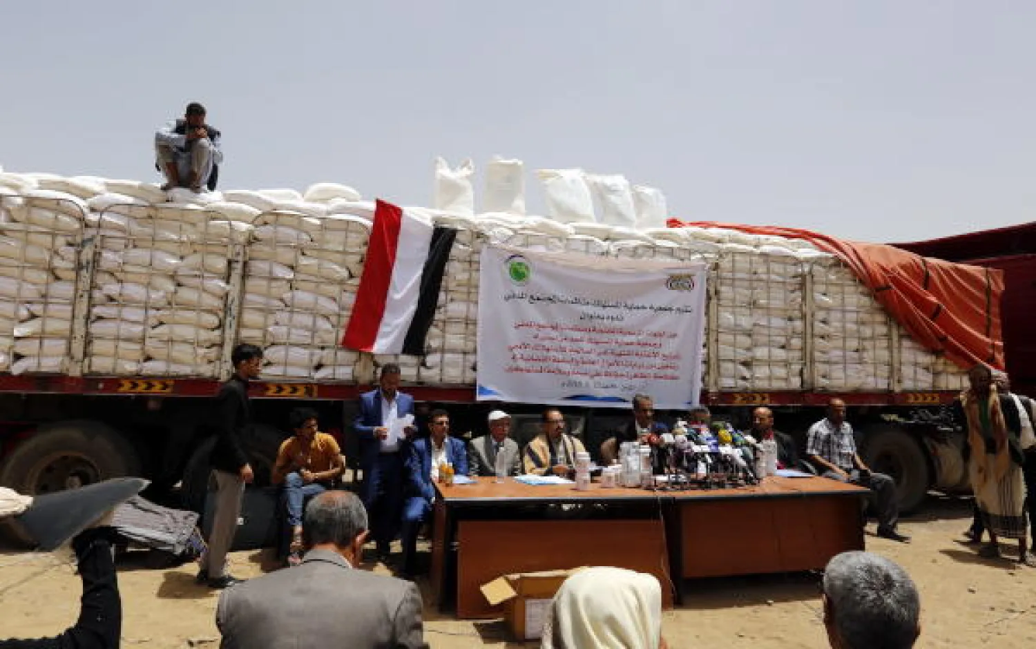 Houthi officials hold a news conference in front of a truck carrying an alleged rotten flour shipment provided by the World Food Programme (WFP) after it was seized by the Houthis in Sanaa, Yemen, 23 June 2019. EPA
