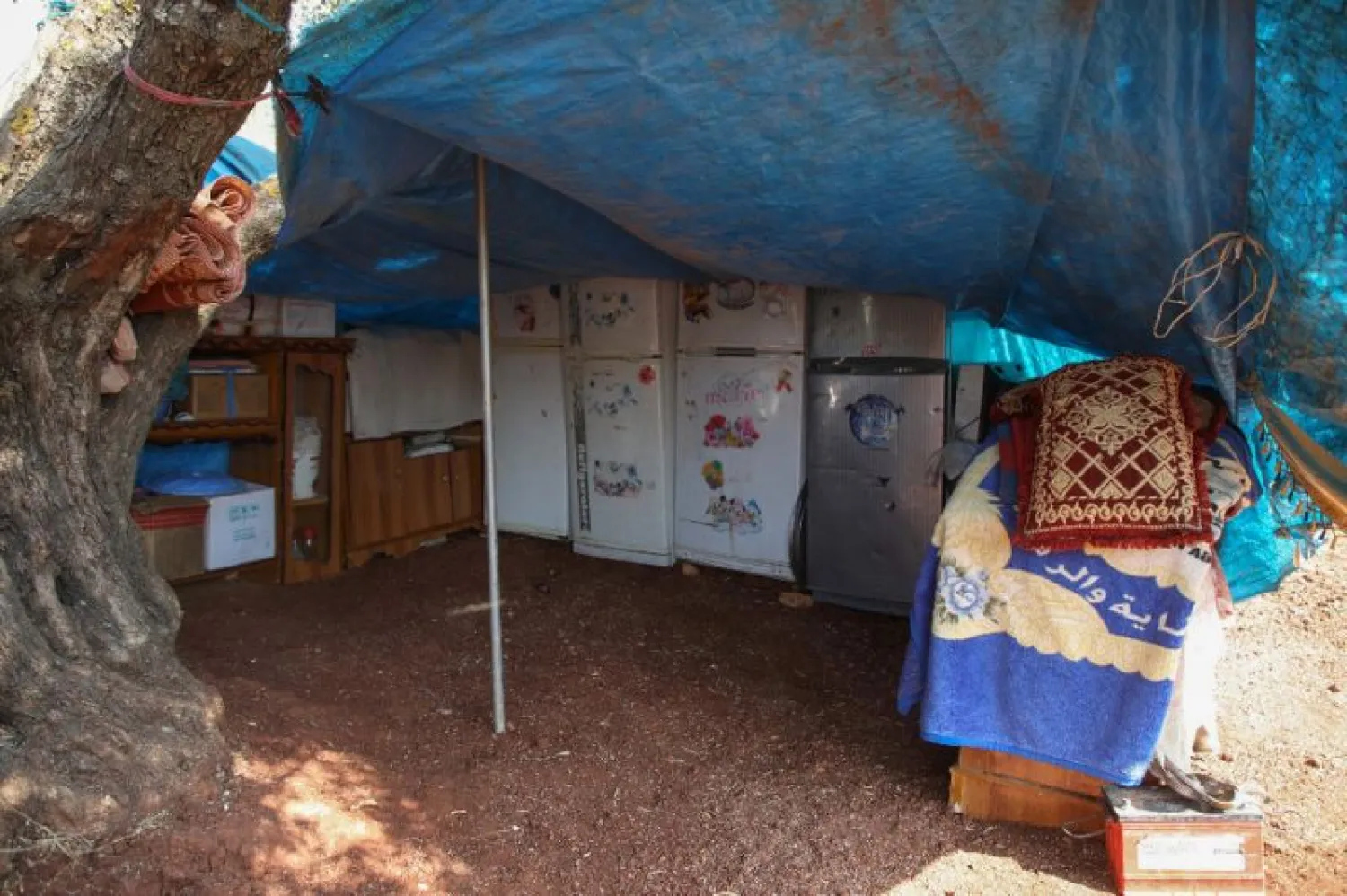 In Atme, some families have stored their fridges and other appliances in a single tent to protect them from the elements | AFP
