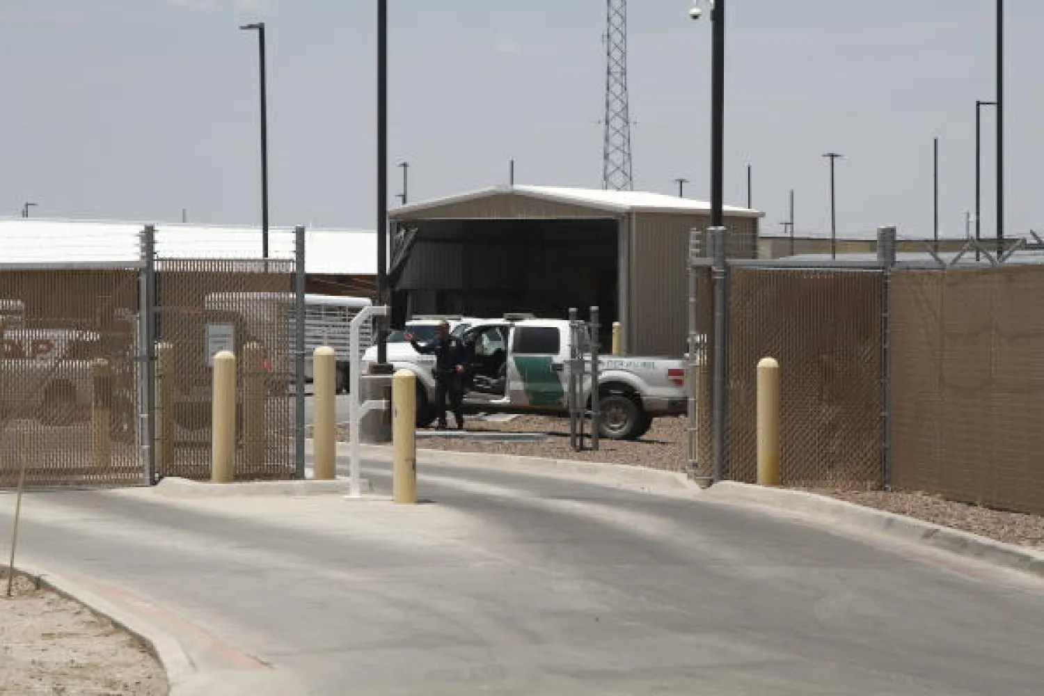 A Customs and Border Patrol officer guards the entrance to the Border Patrol station in Clint, Texas, Wednesday, June 26, 2019. The facility has been a hub for detained children in border patrol custody in New Mexico and West Texas since 2014. (AP Photo/Cedar Attanasio)
