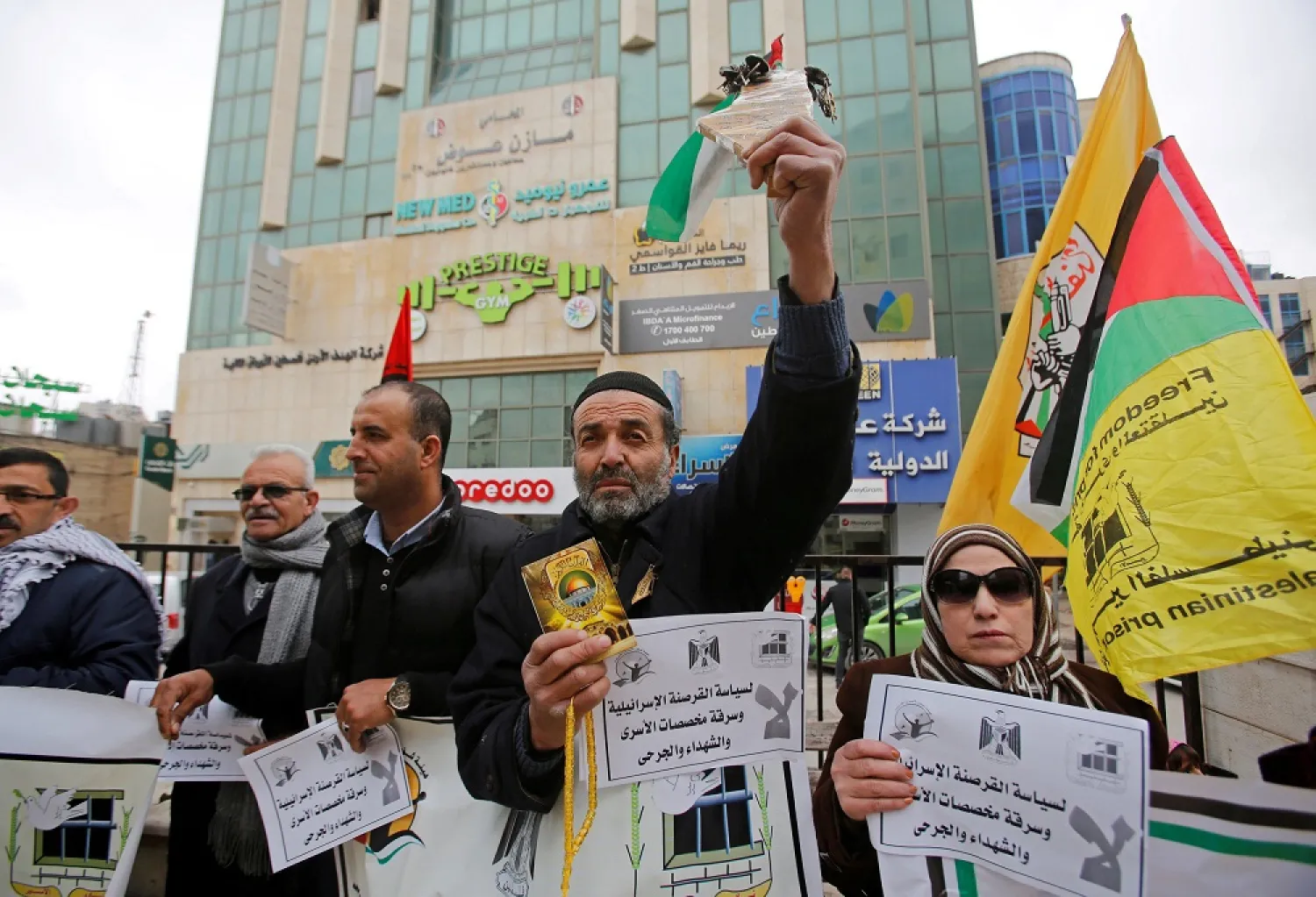 A Palestinian demonstrator takes part in a protest against an Israeli decision to trim funds over prisoner stipends, in Hebron in the Israeli-occupied West Bank, on February 19, 2019. (Reuters)