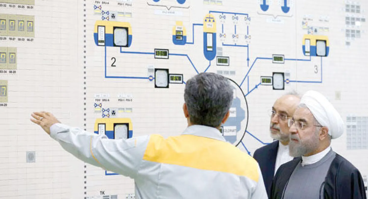 الرئيس الإيراني حسن روحاني يستمع لشرح من أحد التقنيين في مفاعل بوشهر النووي (صورة أرشيفية- أ.ف.ب)