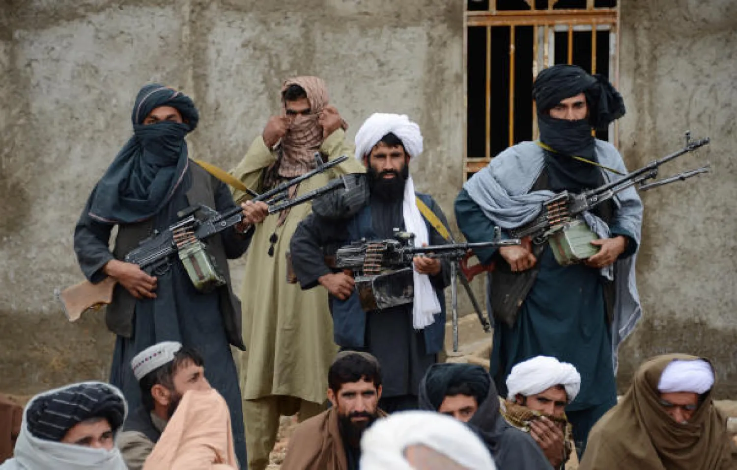 In this Nov. 3, 2015 file photo, Afghan Taliban fighters listen to Mullah Mohammed Rasool, the newly-elected leader of a breakaway faction of the Taliban, in Farah province, Afghanistan. AP