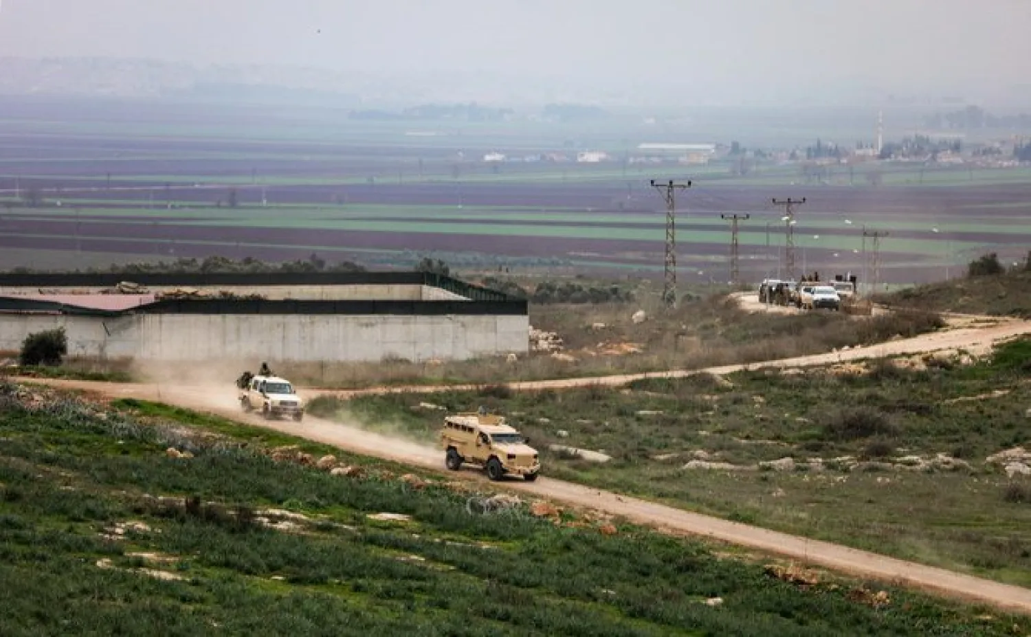 Turkish armored vehicles and Syrian fighters’ pickup trucks drive on the Turkish side of the border in the Reyhanli region of Hatay province in Syria in this February 10, 2018. (AFP)
