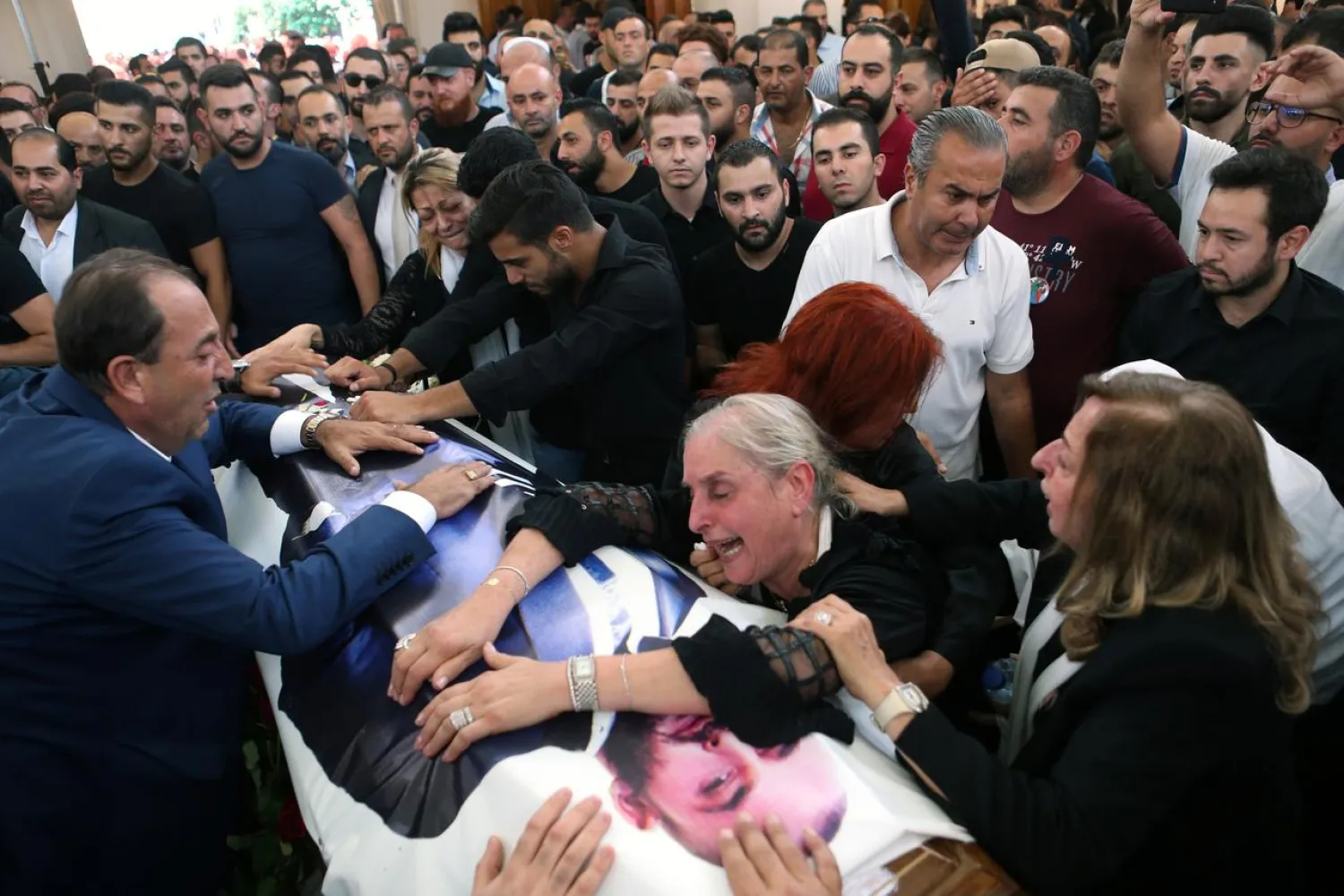 The mother and relatives of Rami Salman, one of two aides of Refugee Affairs Minister Saleh al-Gharib who was killed on Sunday, react during his funeral in Ramlieh, Lebanon July 5, 2019. (Reuters)