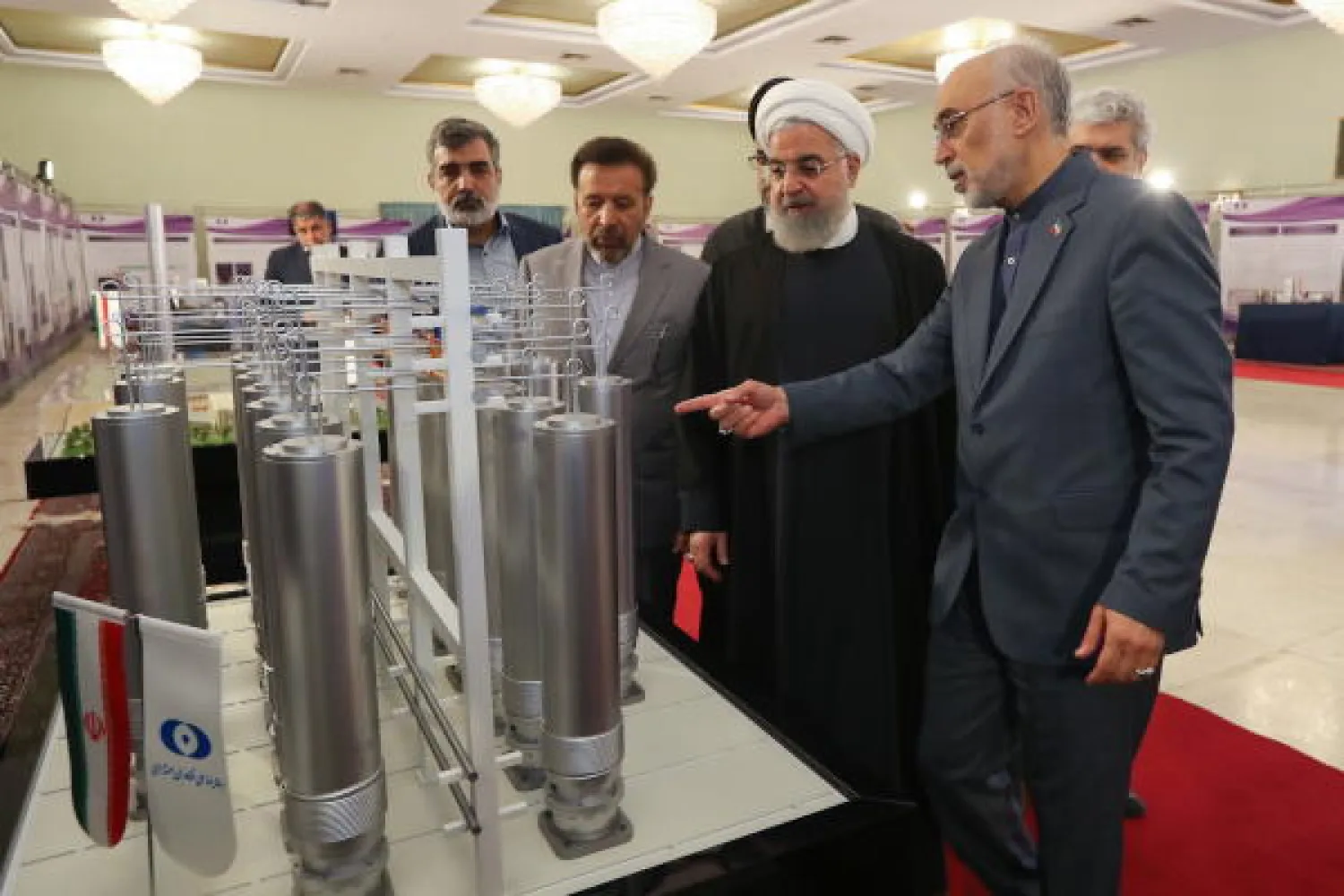 A handout file picture made available by the presidential office shows Iranian President Hassan Rouhani (C) and the head of Iran nuclear technology organization Ali Akbar Salehi inspecting nuclear technology on the occasion of Iran National Nuclear Technology Day in Tehran, Iran, 09 April 2019 (reissued 01 July 2019). AP