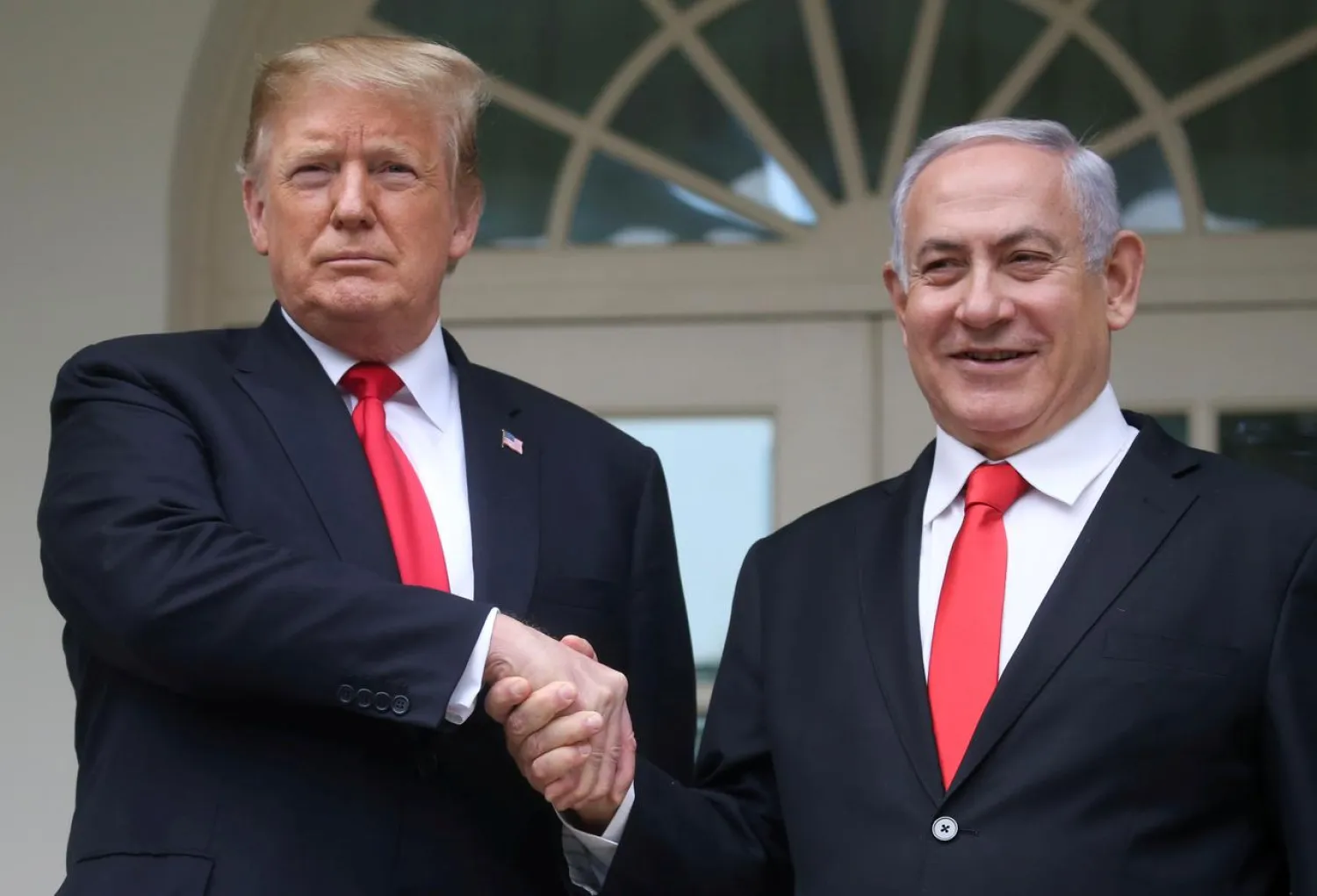 US President Donald Trump shakes hands with Israel's Prime Minister Benjamin Netanyahu as they pose at the White House in Washington, US, March 25, 2019. (Reuters)
