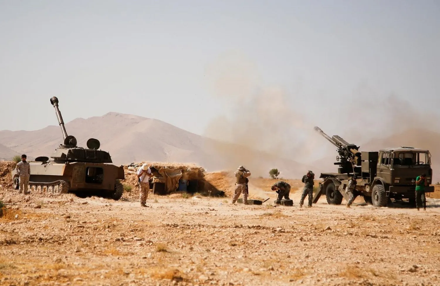 Hezbollah fighters stand near military tanks in Western Qalamoun, Syria August 23, 2017. (Reuters)