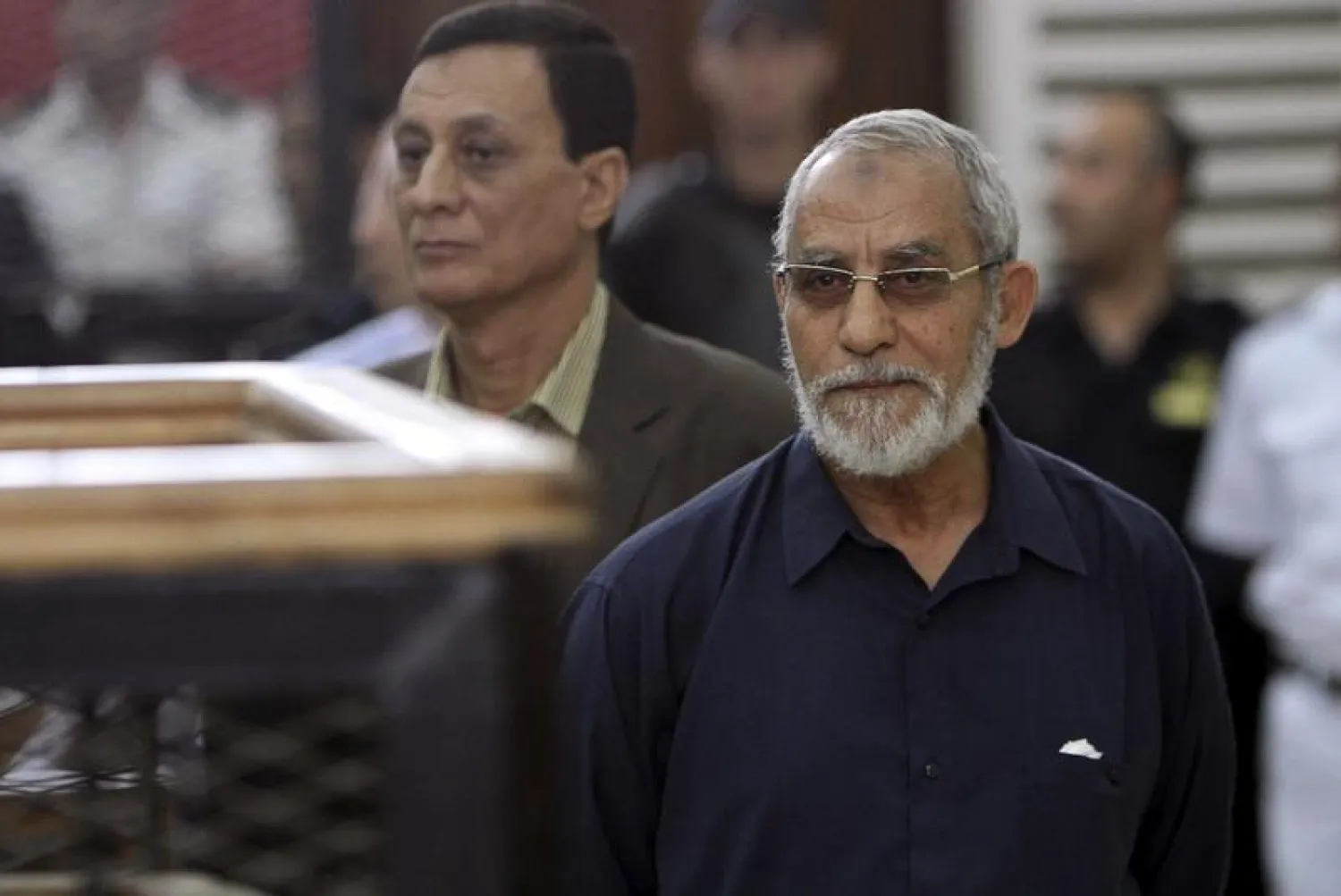 Muslim Brotherhood's Supreme Guide Mohamed Badie (R) looks on during his trial at a court in Cairo (File Photo: Reuters) 
