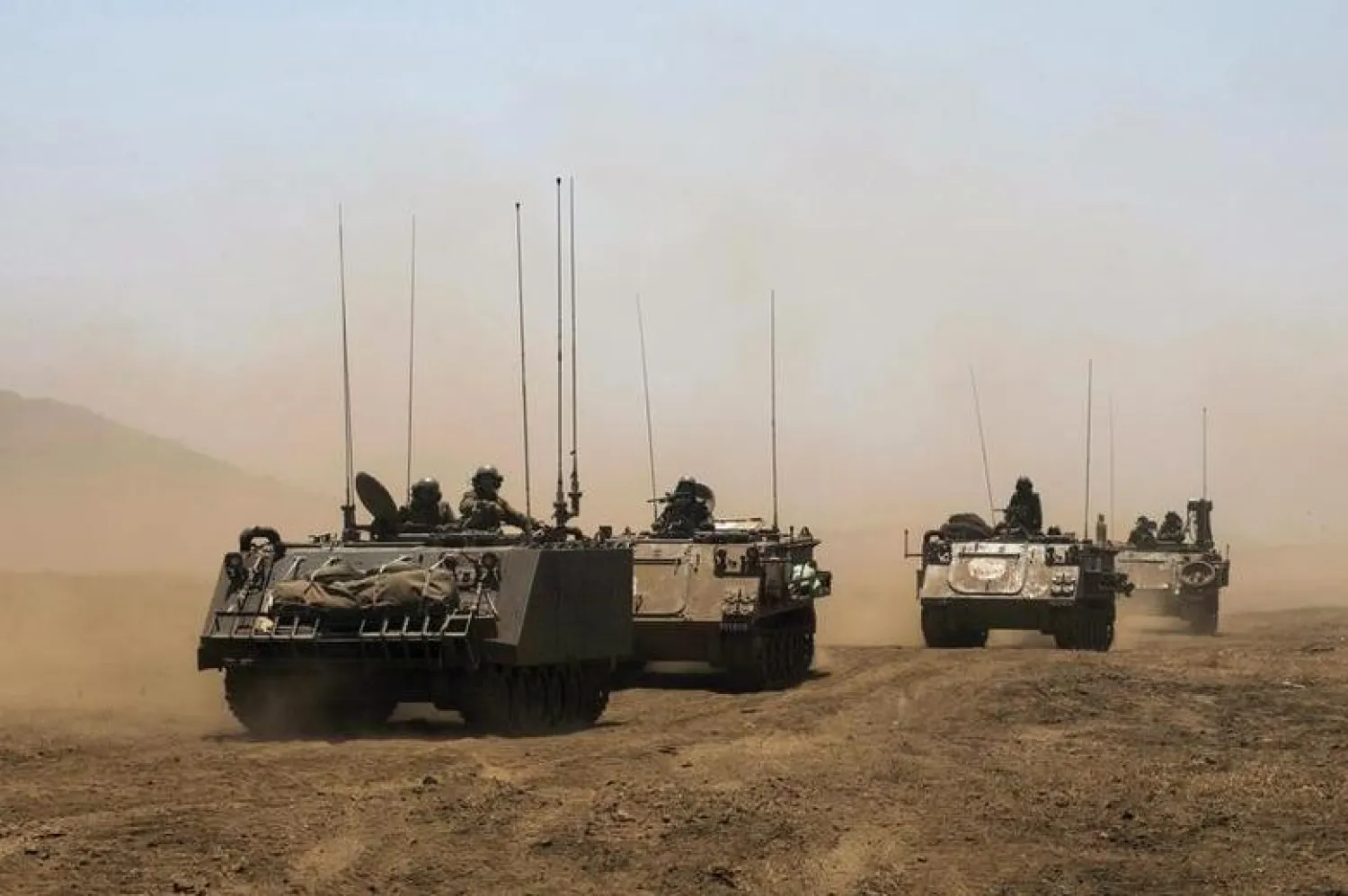 Israeli soldiers ride armored vehicles during an exercise in the Israeli-occupied Golan Heights, near the ceasefire line between Israel and Syria June 17, 2015. REUTERS/Baz Ratner