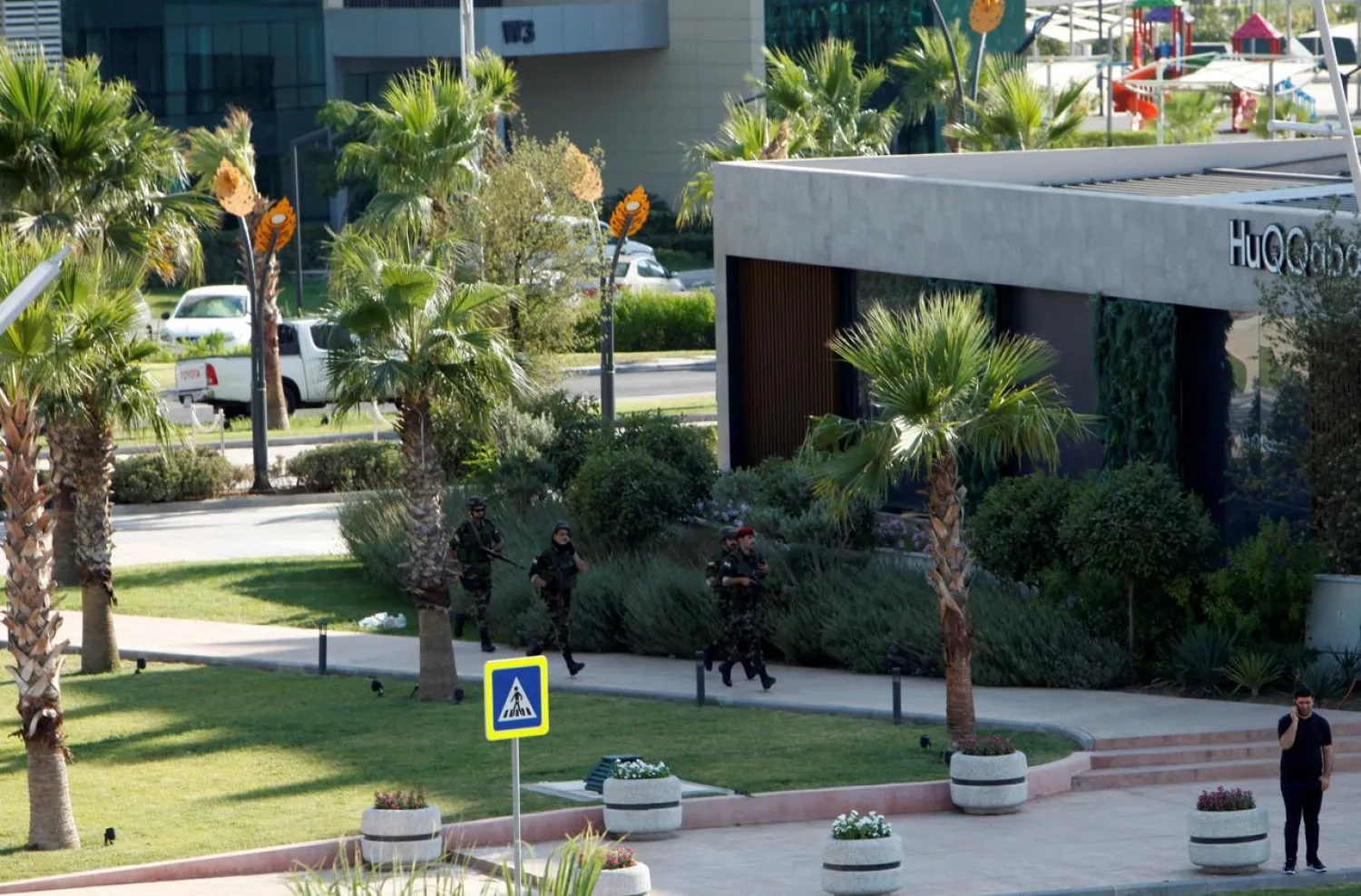 Kurdish security members are seen near a restaurant where a Turkish diplomat and two others were shot dead in Erbil. (Reuters)