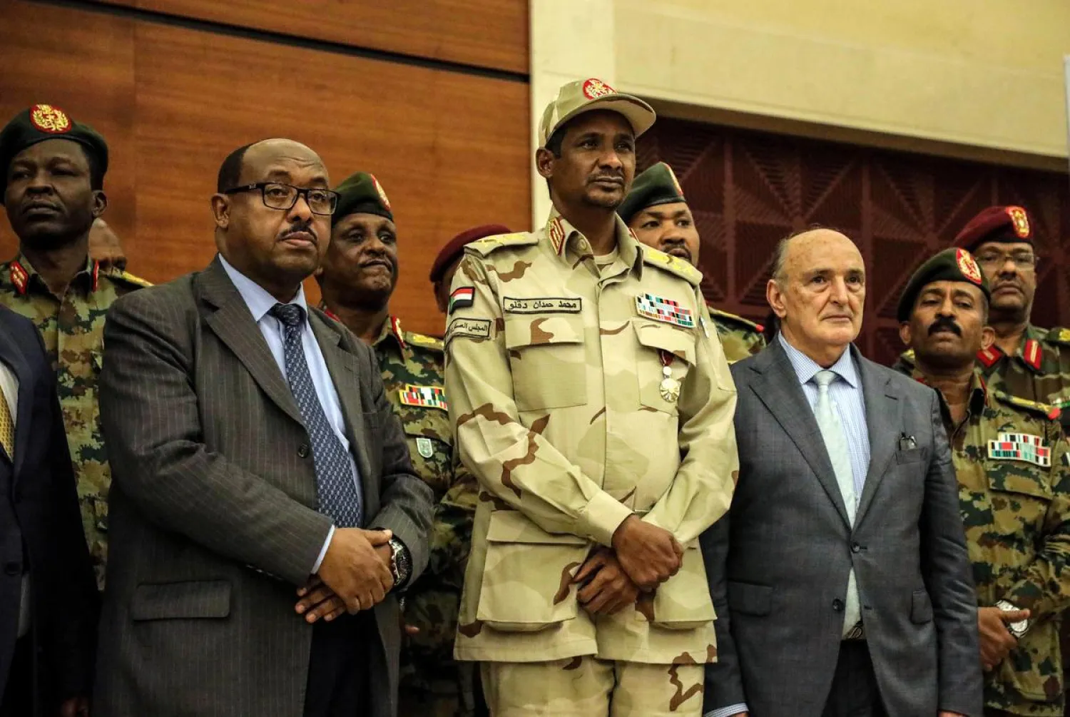 Deputy Head of Sudanese Transitional Military Council, Mohamed Hamdan Dagalo, Ethiopian mediator Mahmoud Dirir and African union envoy to Sudan Mohamed Al-Hacen Lebatt pose for a photograph after signing a political accord as part of a power-sharing deal aimed at leading the country to democracy following three decades of autocratic rule in Khartoum, Sudan July 17, 2019. REUTERS/Stringer
